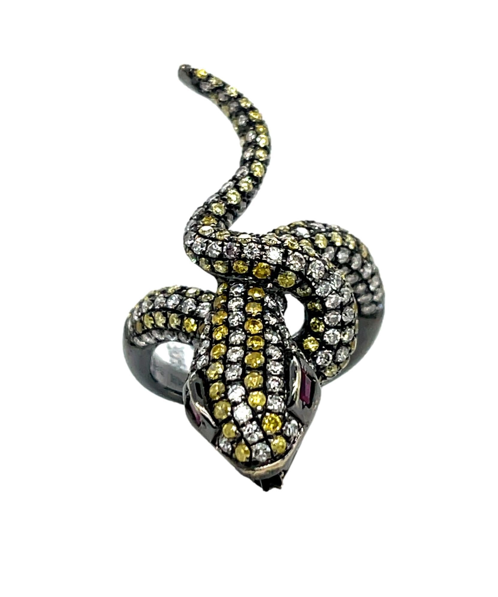 This one of a kind serpent ring has over 120 round fancy colored brilliant cut diamonds and is a perfect ring for that special event. There are two natural tapered baguette Rubies for the eyes for a perfect accent. This ring will be the talk of your