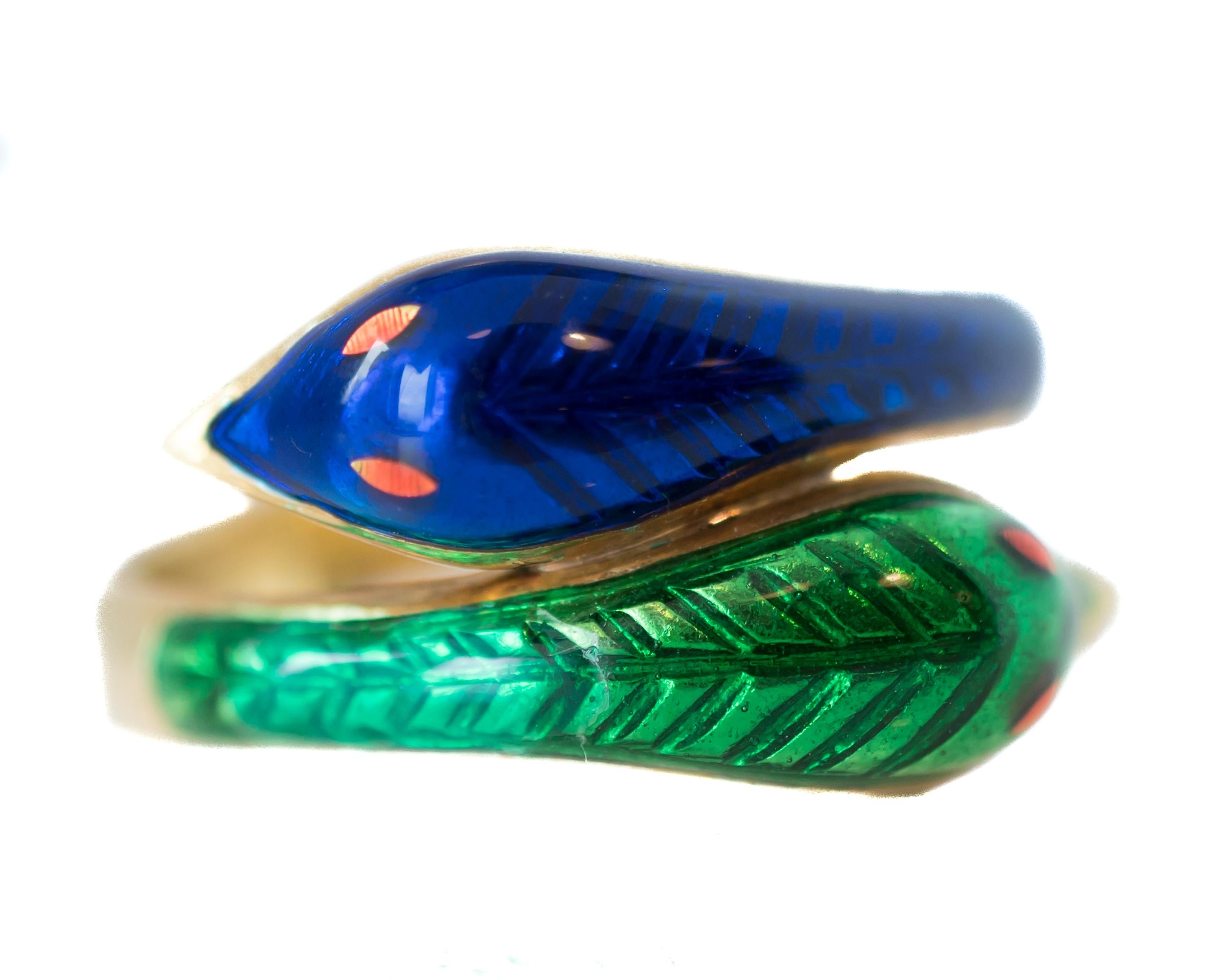 Two-Headed Snake Ring - 18 Karat Yellow Gold, Enamel


Colorful, gorgeous ring with amazing detail. The upper shank has 2 snake heads framed in 18 karat Yellow Gold. One head has deep, lapis blue enamel, the other has an emerald green enamel. Each