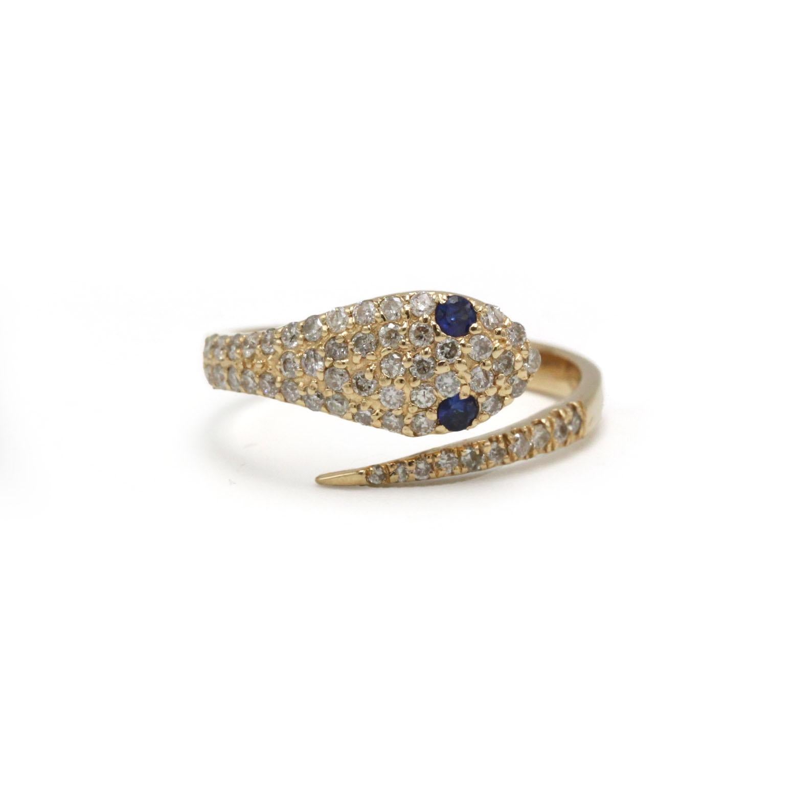 This elegant serpent ring in 14K yellow gold is set with a shimmering pavé of round brilliant-cut diamonds totaling 0.44 carats, accented by two deep blue sapphire eyes that bring the motif to life. Designed in a graceful coiled silhouette, the ring