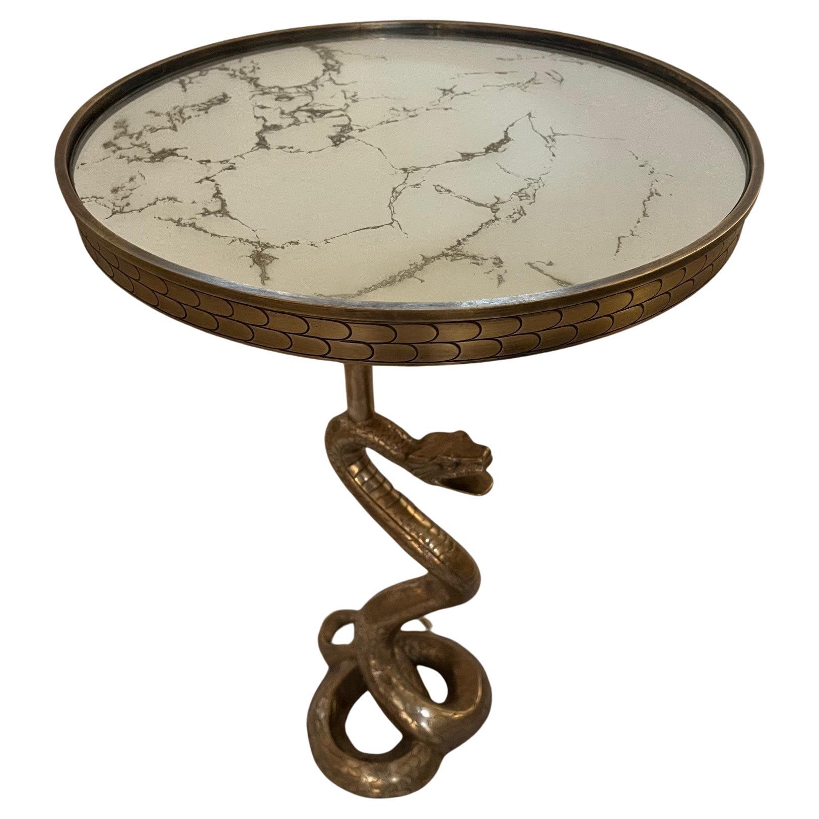 brass snake base with Mirrored top. Brass top has scale detailing on apron and antiqued mirror with gold veining.

  