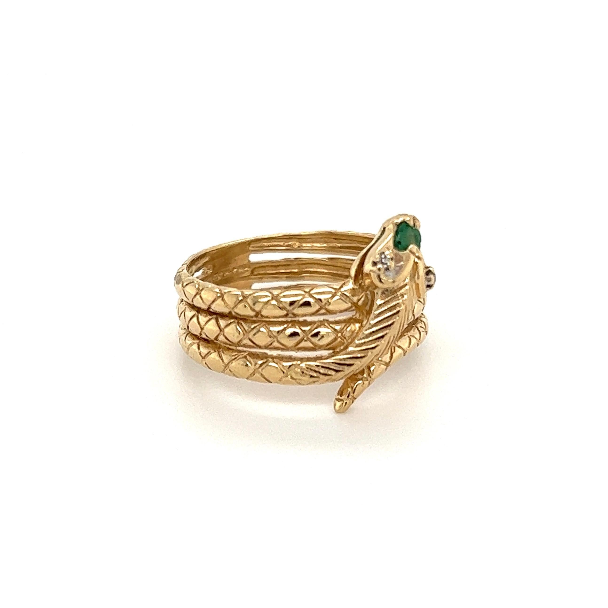 Striking Serpent Snake Ring. Hand crafted in 10K Yellow Gold with hand-engraved scales. This piece has a wonderful, old-world charm. Hand set with an Emerald and 0.01tcw Diamond Brilliant-Cut Diamond. A wonderful decadent example of the Egyptian