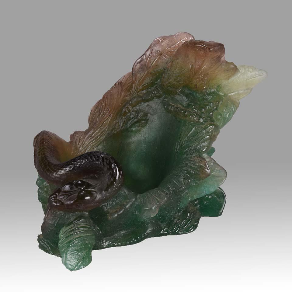 Entrancing mid 20th Century French pate-de-verre vide-poche decorated with variegated colours of greens and browns with a raised figure of a snake exhibiting fine translucent colour and excellent hand finished surface detail, signed Daum France to