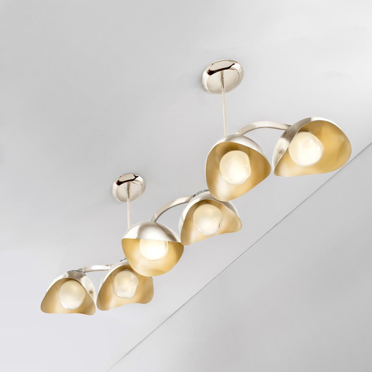 The Serpente ceiling light features a gently winding frame to which are mounted six organic shades. Each shade cradles one of our Sfera glasses on the inside and a clear molded glass on top: both handblown in Murano. The fixture can be suspended by