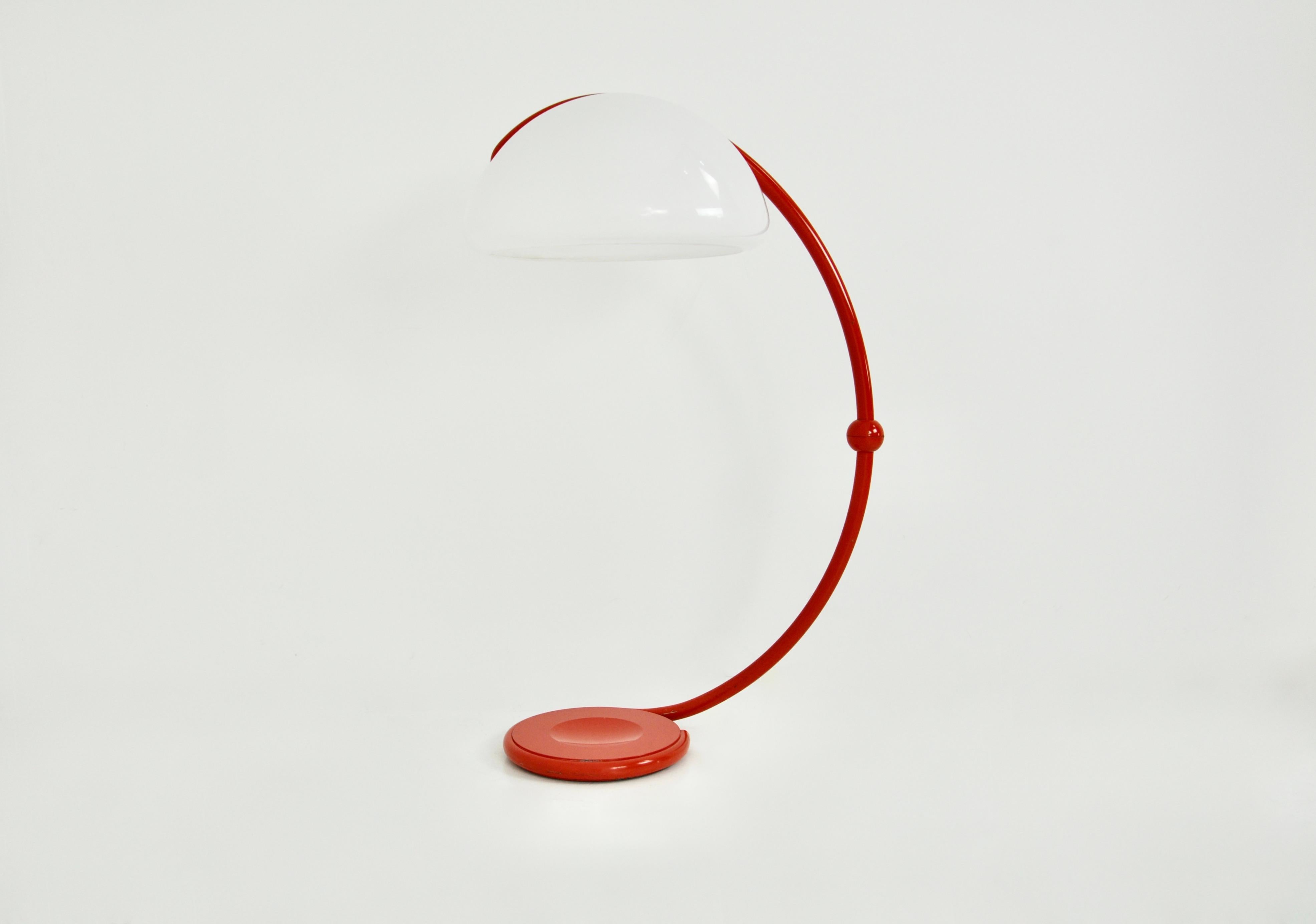 Italian articulated floor lamp, orange colour, in metal and plastic. Wear due to time and age of the lamp.