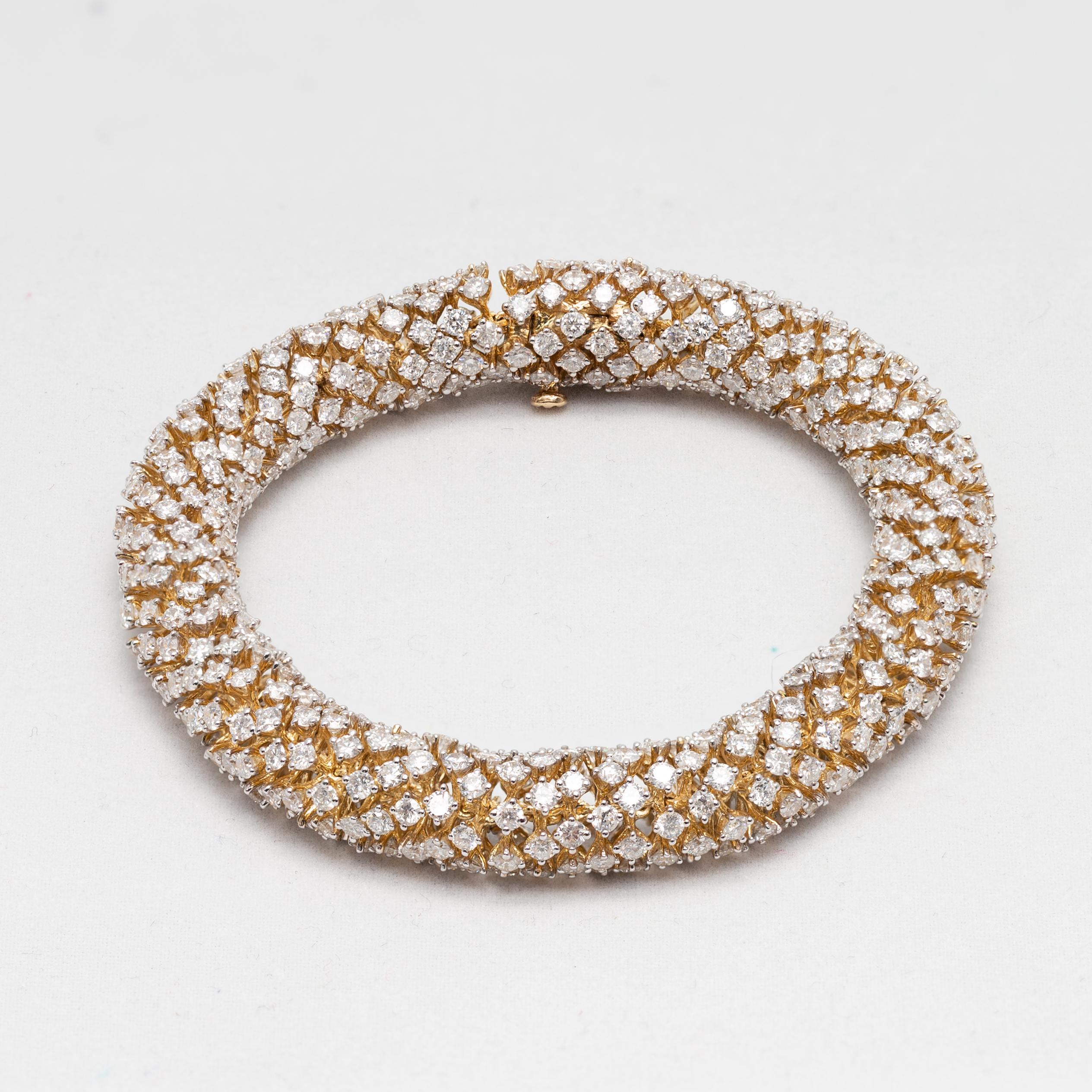 A 14 karat Modern yellow Gold and Diamond semi-flexible bracelet with serpentine movement. Our eyes are immediately drawn to this spectacular semi-flexible bracelet, set in 14 karat yellow Gold and accented with a delicate rhythm of sparkly Diamonds