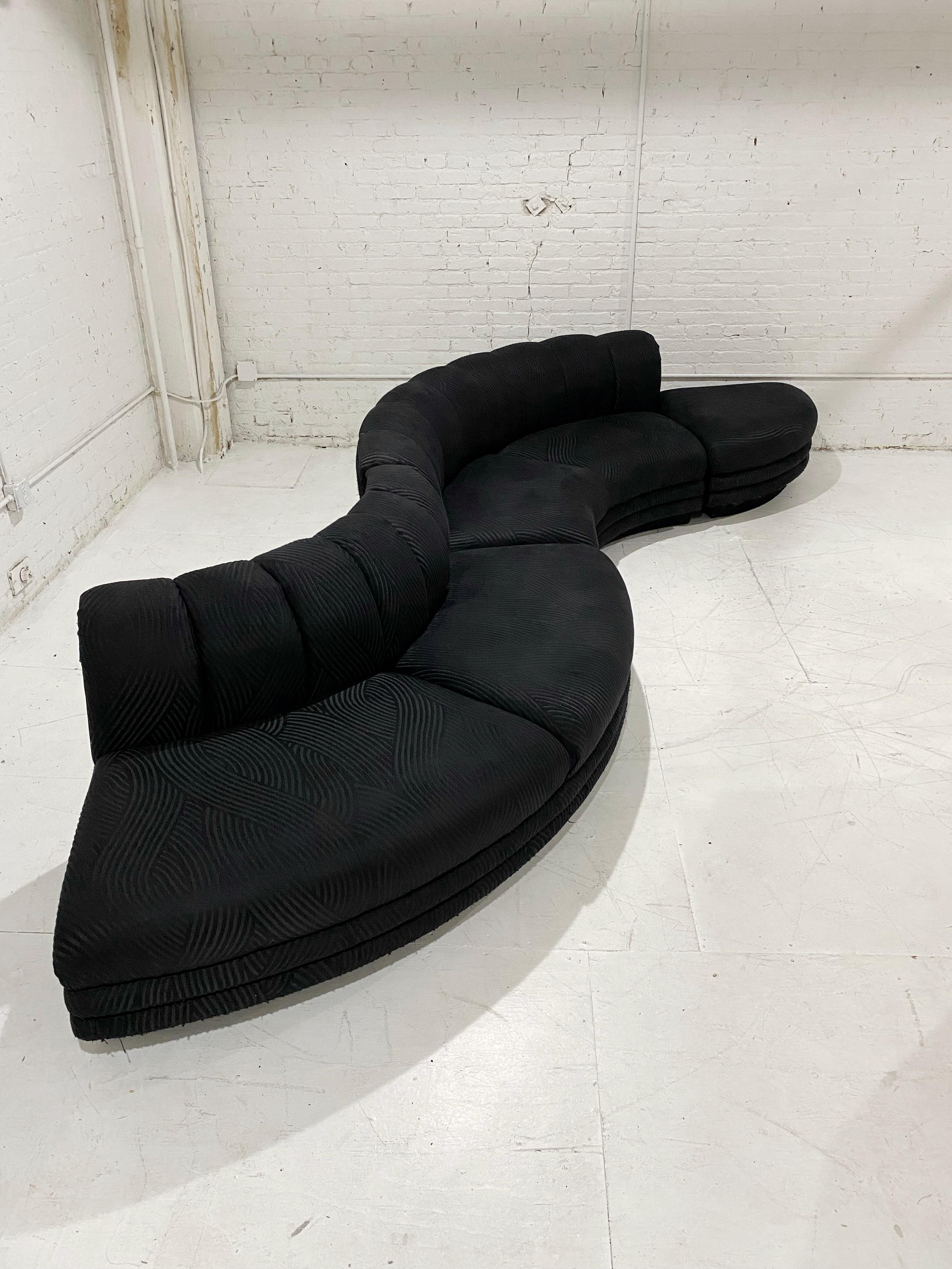 A post modern 3 piece serpentine sectional in original jacquard fabric. Pieces can be arranged at your discretion to alter overall shape. Reupholstery recommended.

Additional measurements:
Ottoman piece: 33” W x 33” D x 16” H
Curved piece: 85”