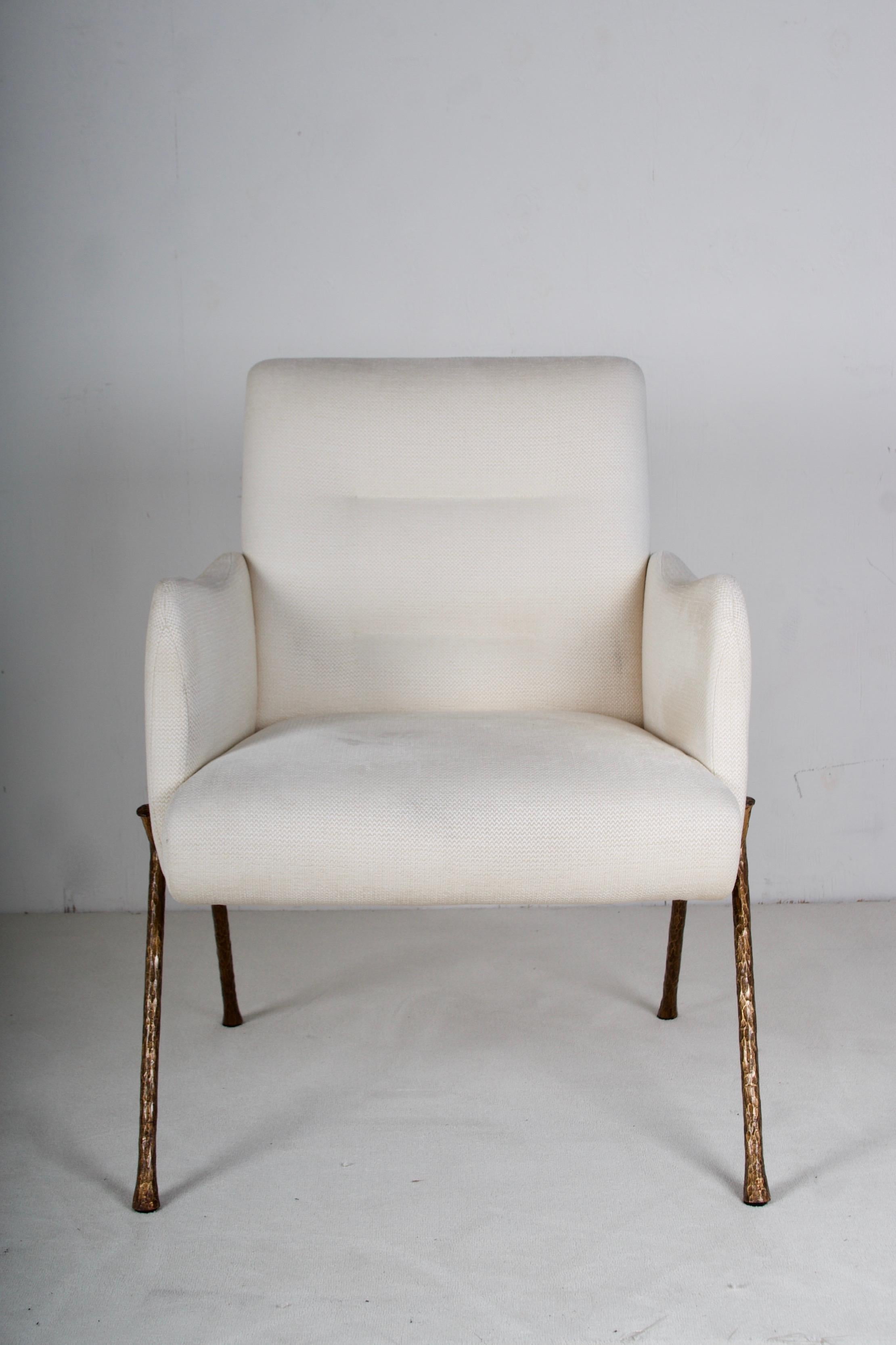 A very lovely armchair fully upholstered, legs in hammered
bronze. The linen blend fabric is slightly soiled but in great
condition.

There are three chairs available.