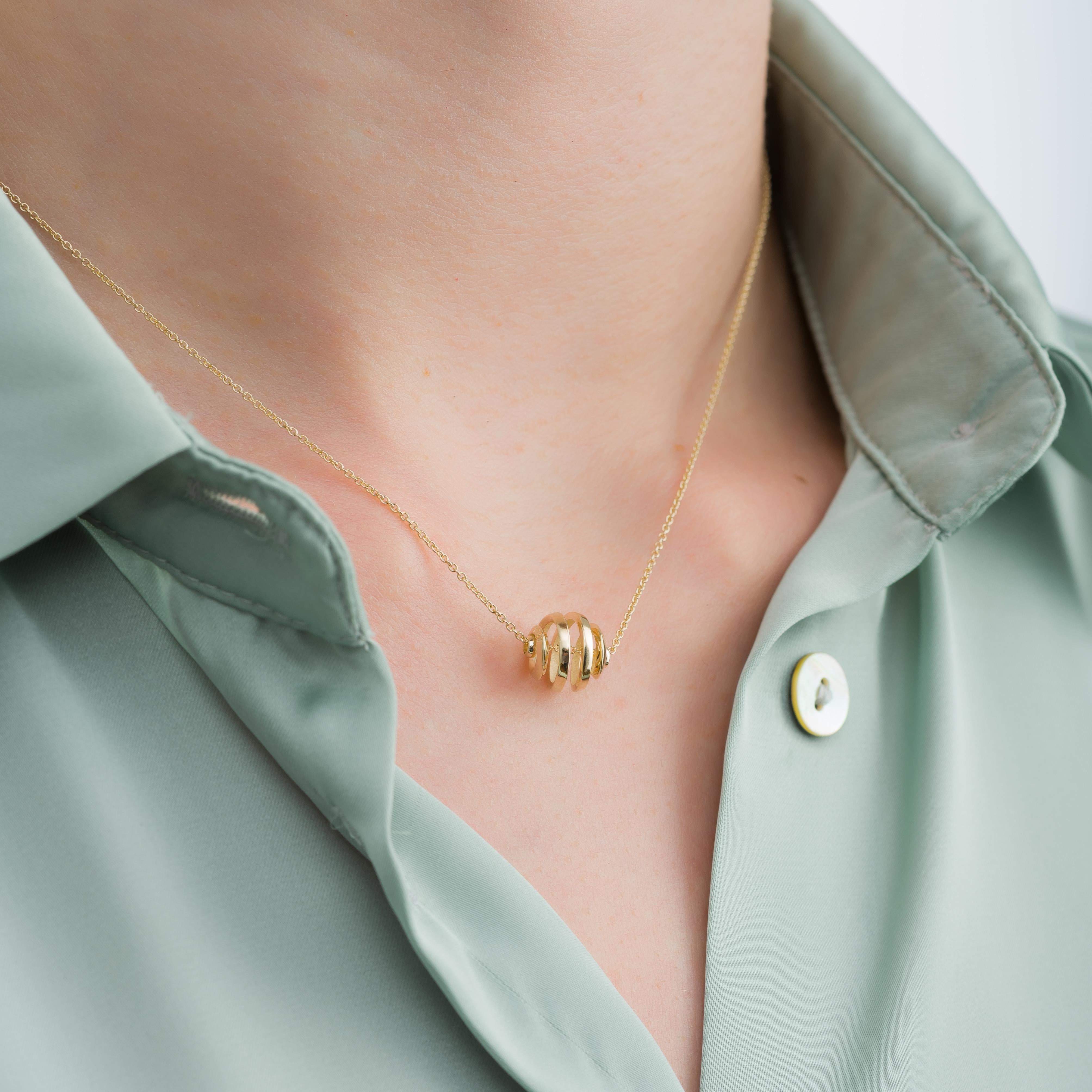 Embrace the allure of our exquisite gold ball serpentine pendant, where the artistry of serpentine curves harmonizes with the brilliance of gold—an embodiment of refined elegance and graceful allure, capturing the essence of timeless