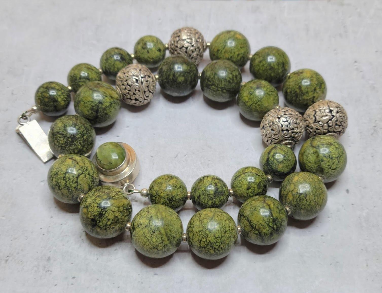 The length of the necklace is 20.5 inches (52 cm). The size of beads varies from 14 mm to 18 mm.
The color of the beads is a mix of various shades of green, light green, dark green, and yellow.
The color is authentic and natural. No thermal or other