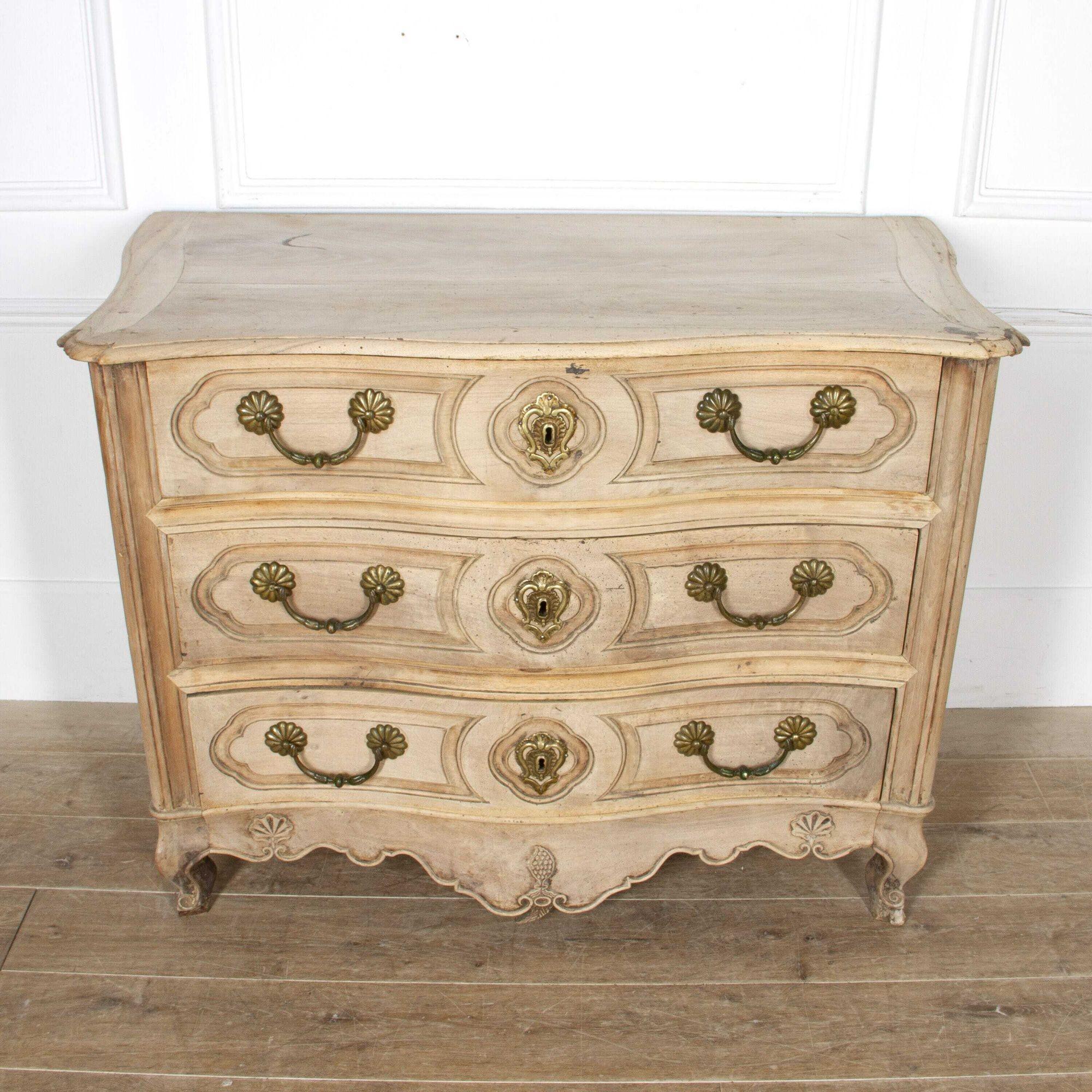 Impressive 19th Century serpentine commode. 
This wonderful commode has recently been bleached to reveal a fantastic colour and graining throughout. 
This shapely and tactile piece has three large drawers; all fully functional. 
Each drawer is