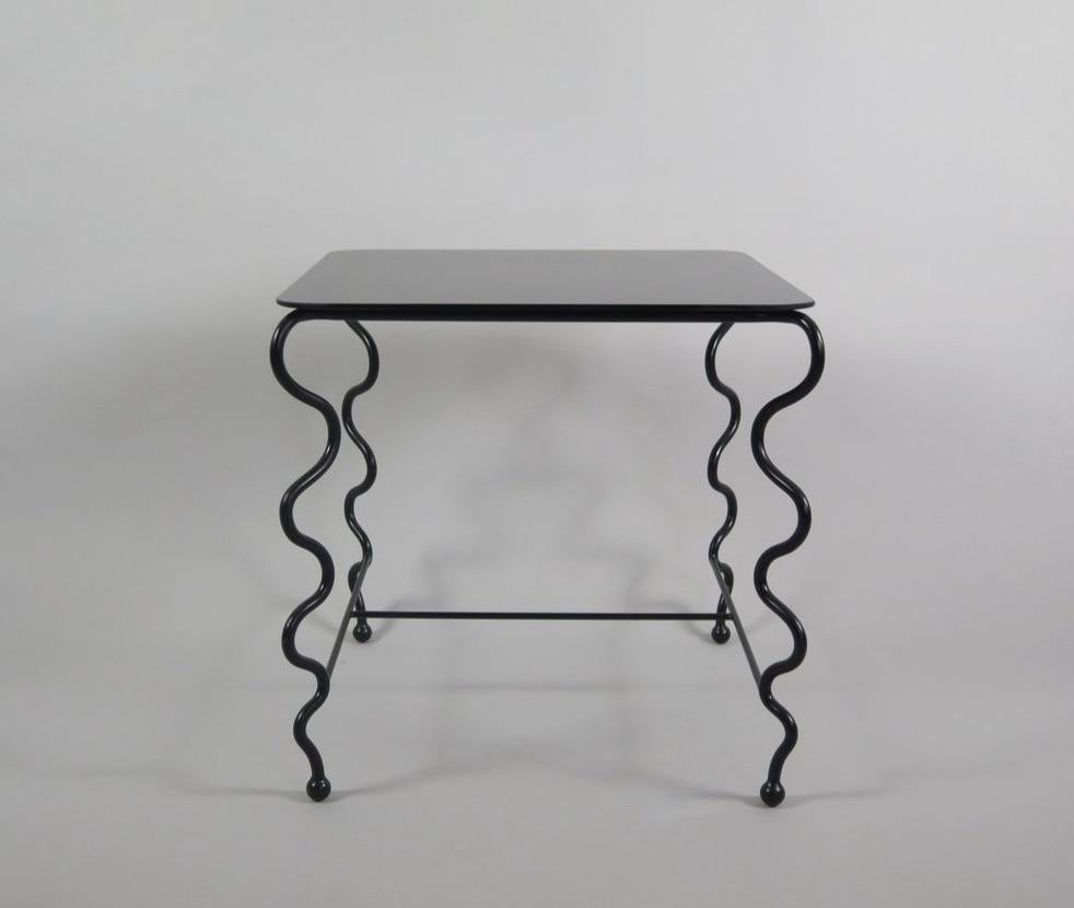 Contemporary hand-forged 'Serpentine' Cocktail Table by Matthew Sidow.

Black wrought iron base with undulating legs and black glass top. Each piece is handmade by our skilled artisans in the United States.

Please inquire for customization requests.