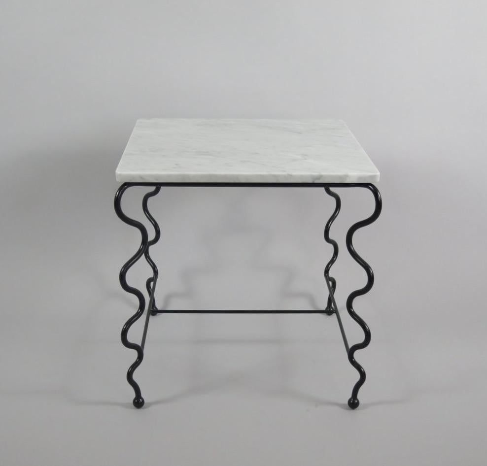 Contemporary hand-forged 'Serpentine' Cocktail Table by Matthew Sidow.

Black wrought iron base with undulating legs and Carrara marble top. Each piece is handmade by our skilled artisans in the United States.

Please inquire for customization