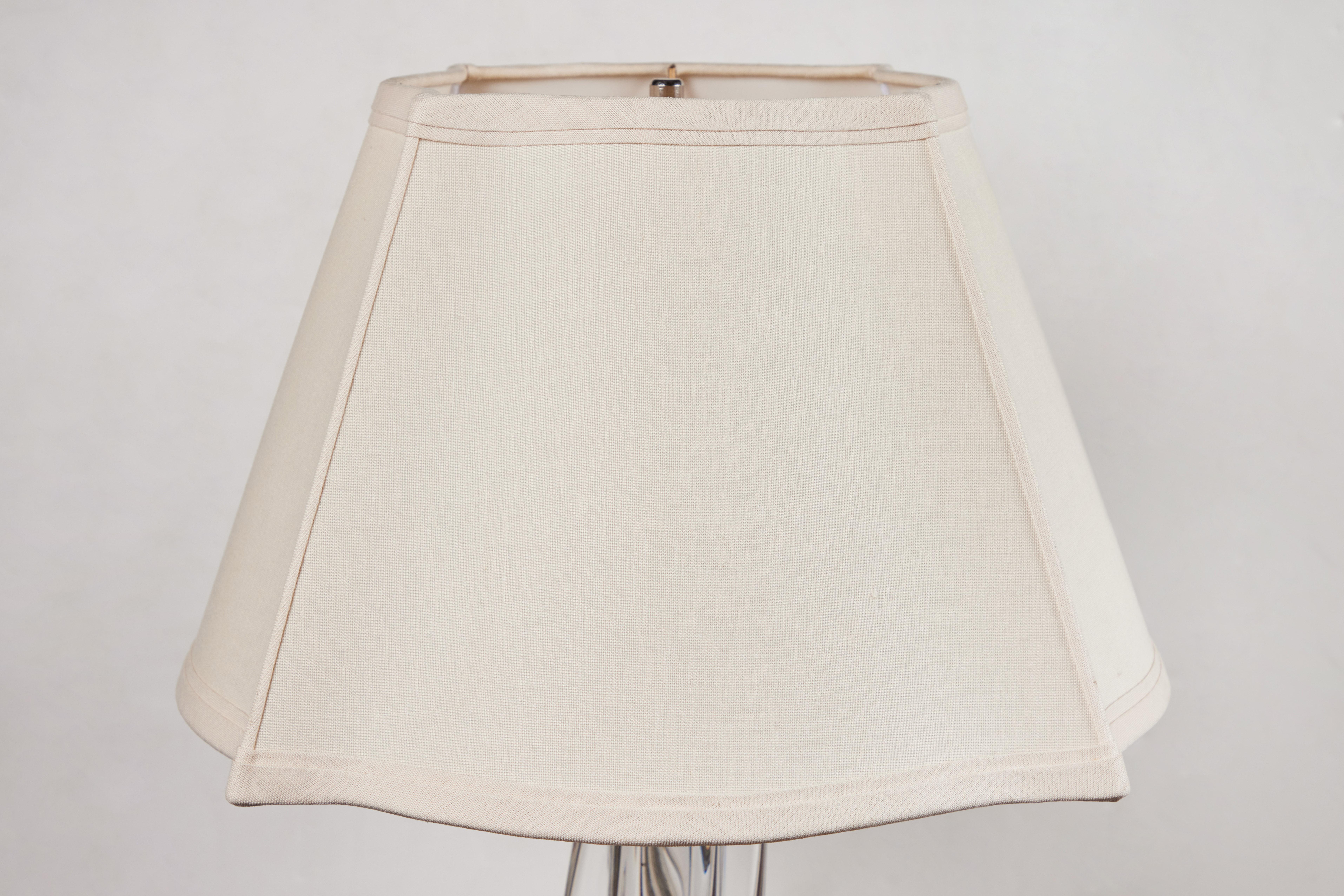 A c. 1940, Continental, organic-form, solid crystal table lamp with intertwining extrusions. Surmounted by a custom shade. Now wired for U.S. current. Measures: Shade diameter: 18.5
