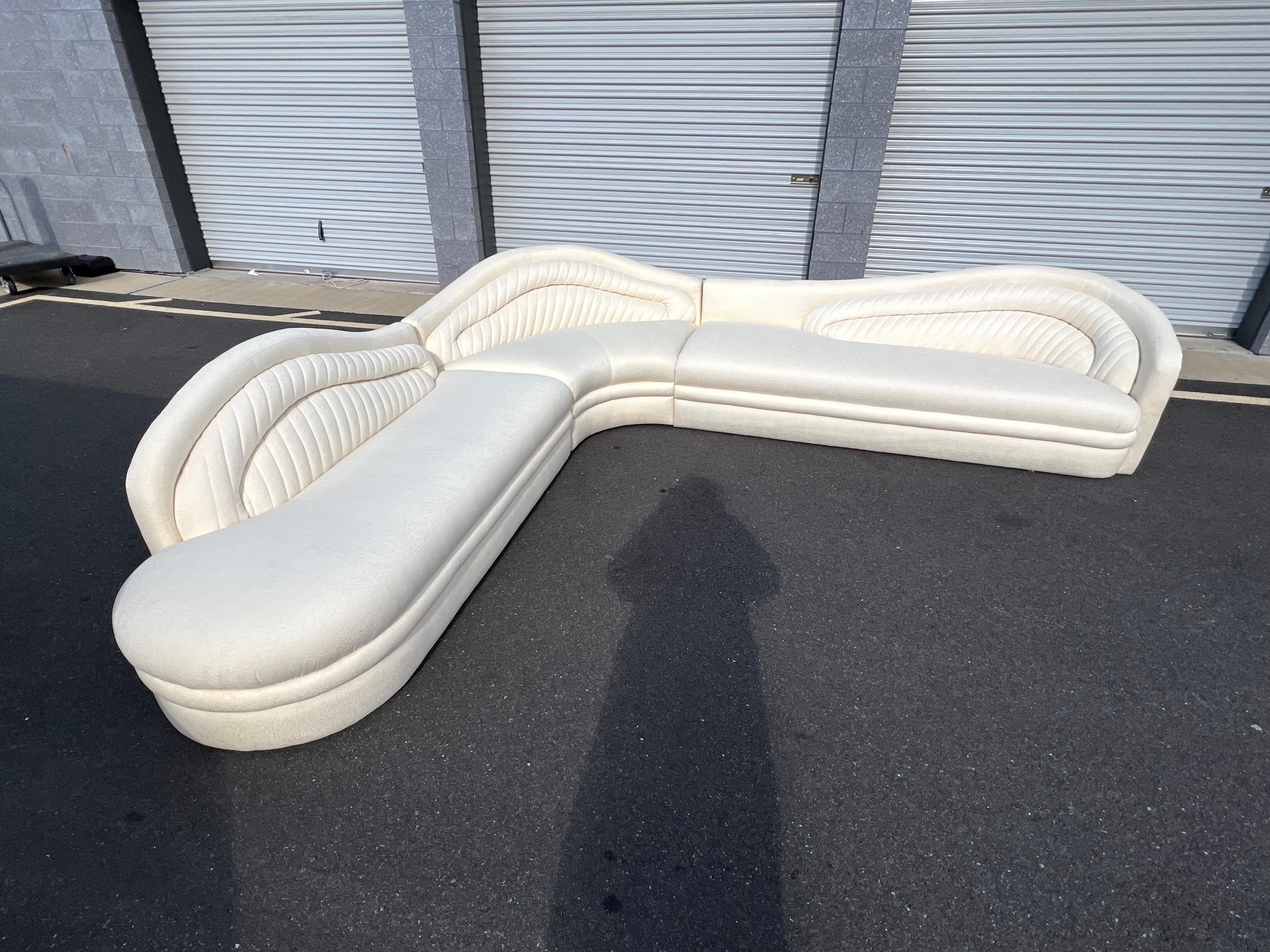 This sectional is custom made by Weiman (See the label in the last photo) in the style of Vladimir Kagan

The sectional has 3 pieces. One of the most unique features of this sectional is the details of the cloud shaped like seat. The wavy curvy