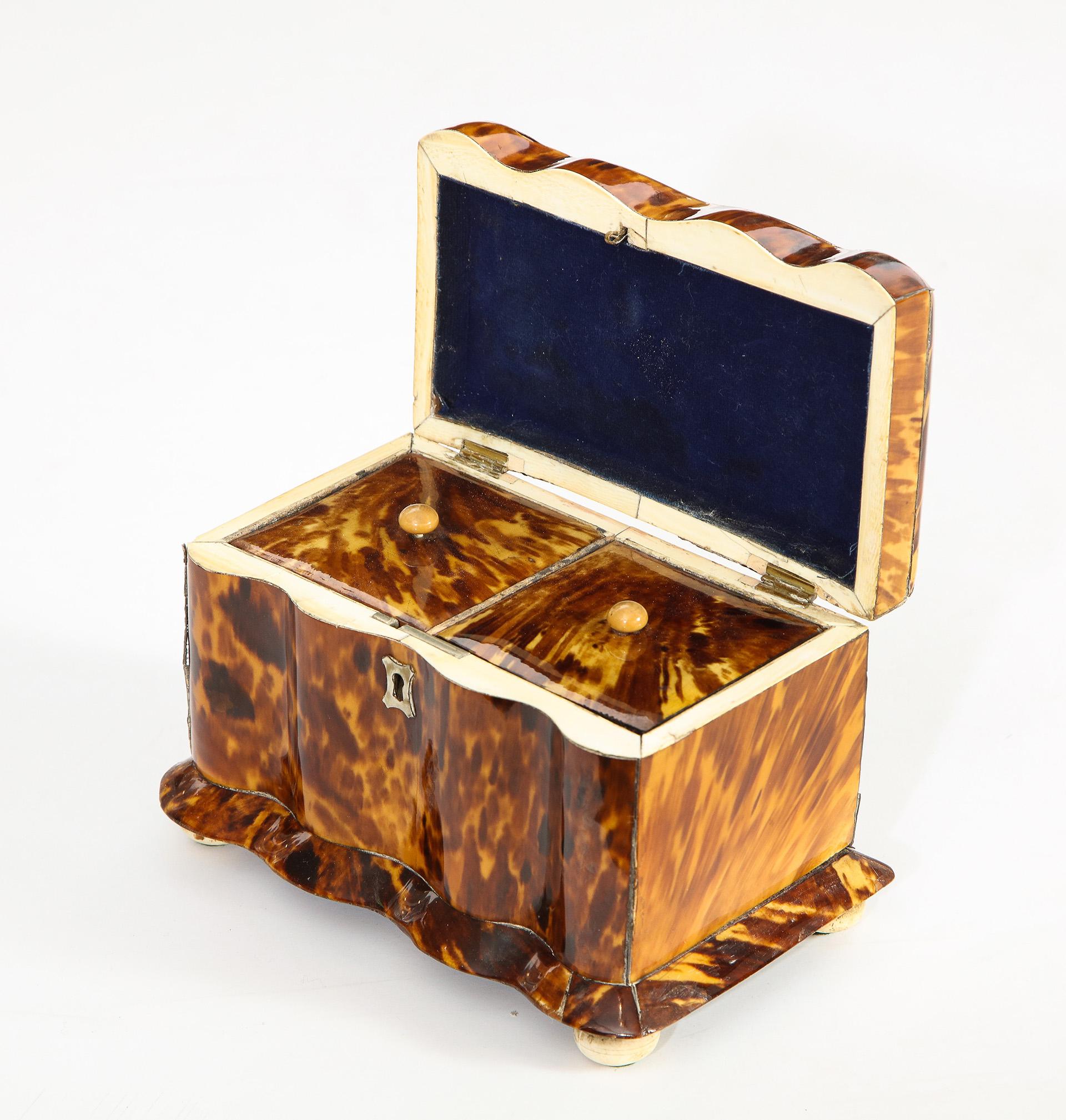 Rare serpentine form English Regency tea caddy. The base with sloping sides, the interior with two fitted compartments.

