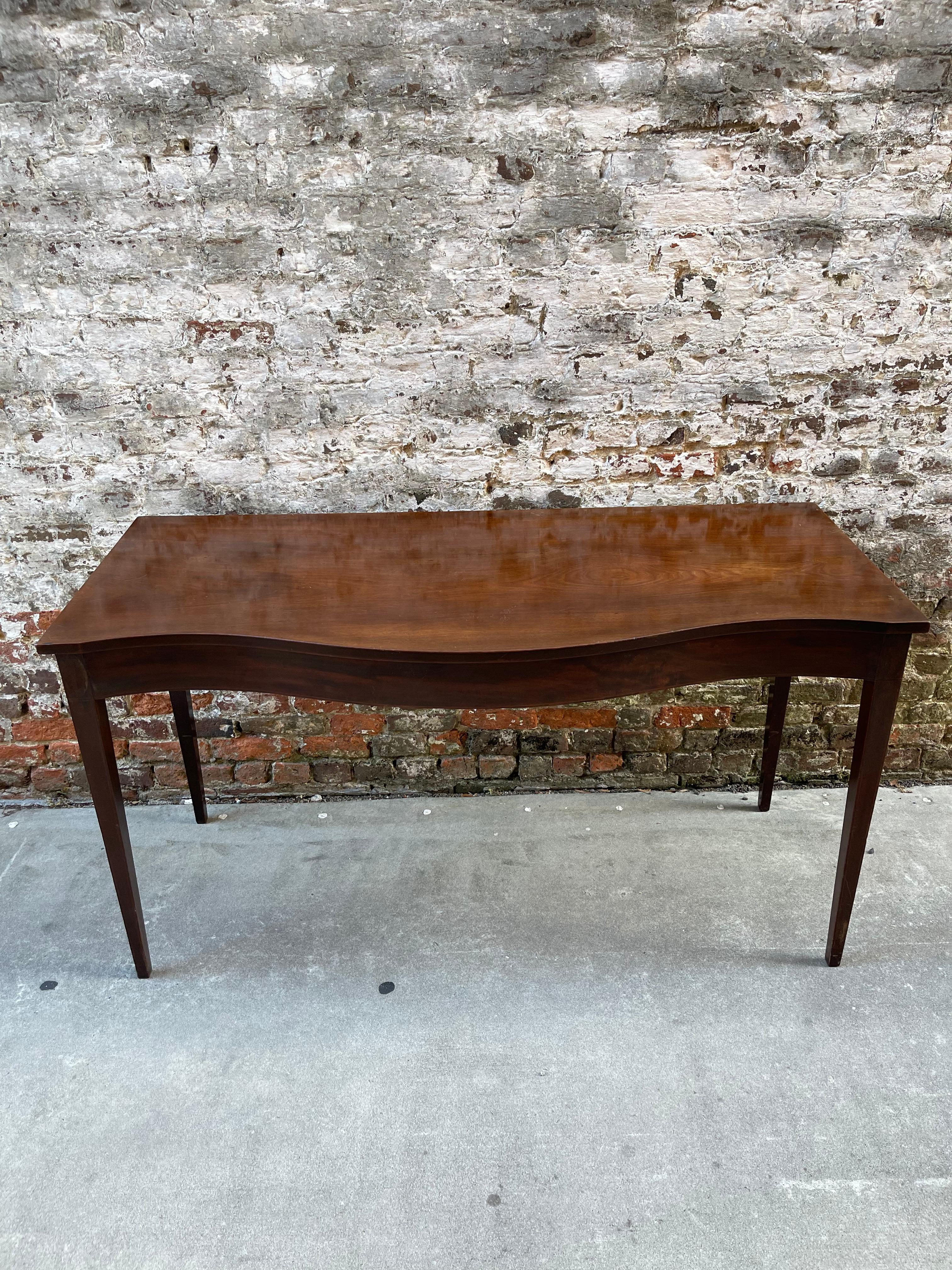 Serpentine front mahogany server or console table late 19th century.