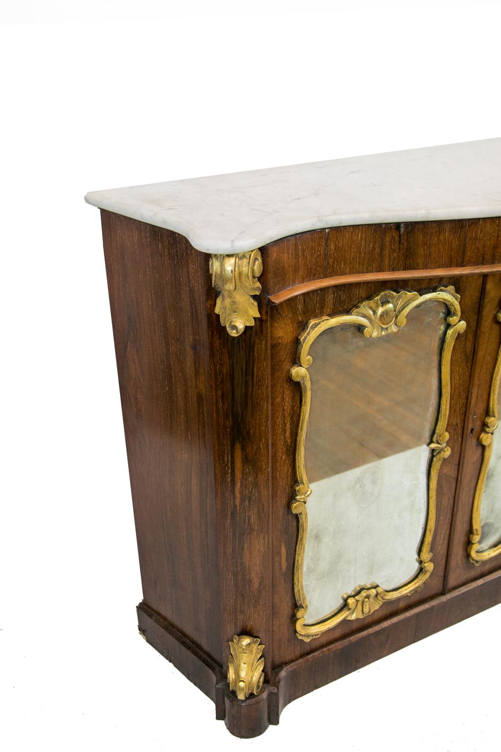 Serpentine rosewood marble-top console, has carved gilt mounts and mirror frames.
 