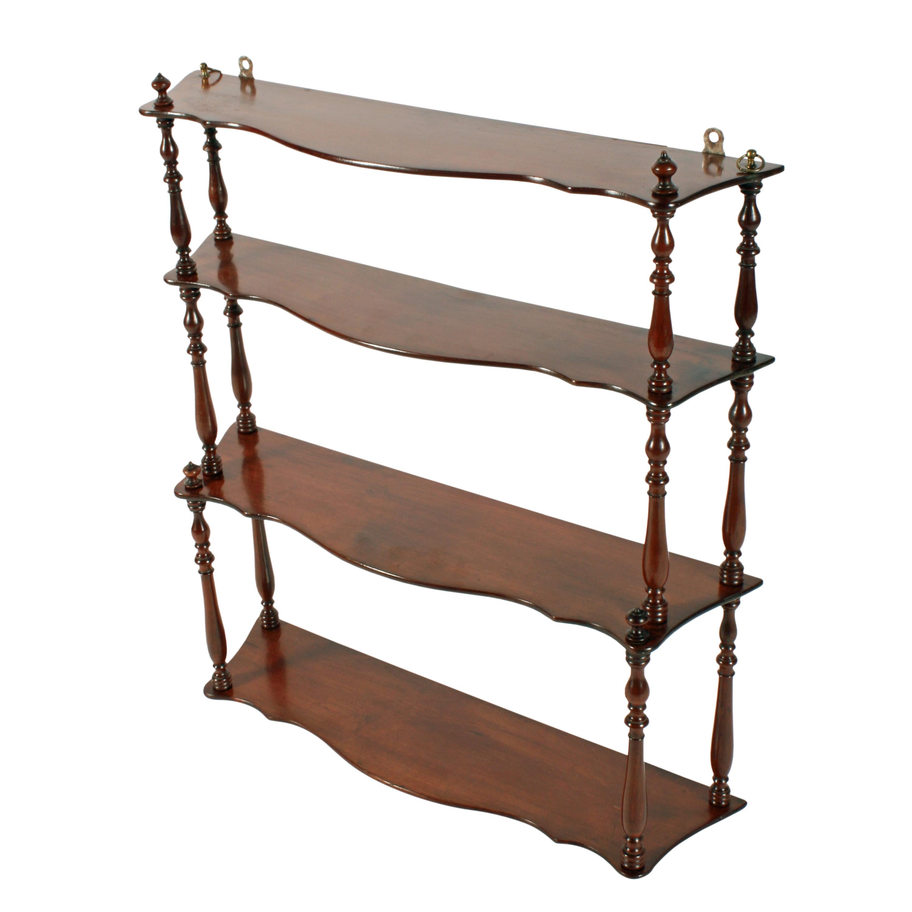 A set of mid-19th century mahogany wall shelves.

The shelves have serpentine shaped fronts, turned supports between each shelf and the bottom two shelves are deeper than the top two.

The shelves are in good condition and can be hung by brass
