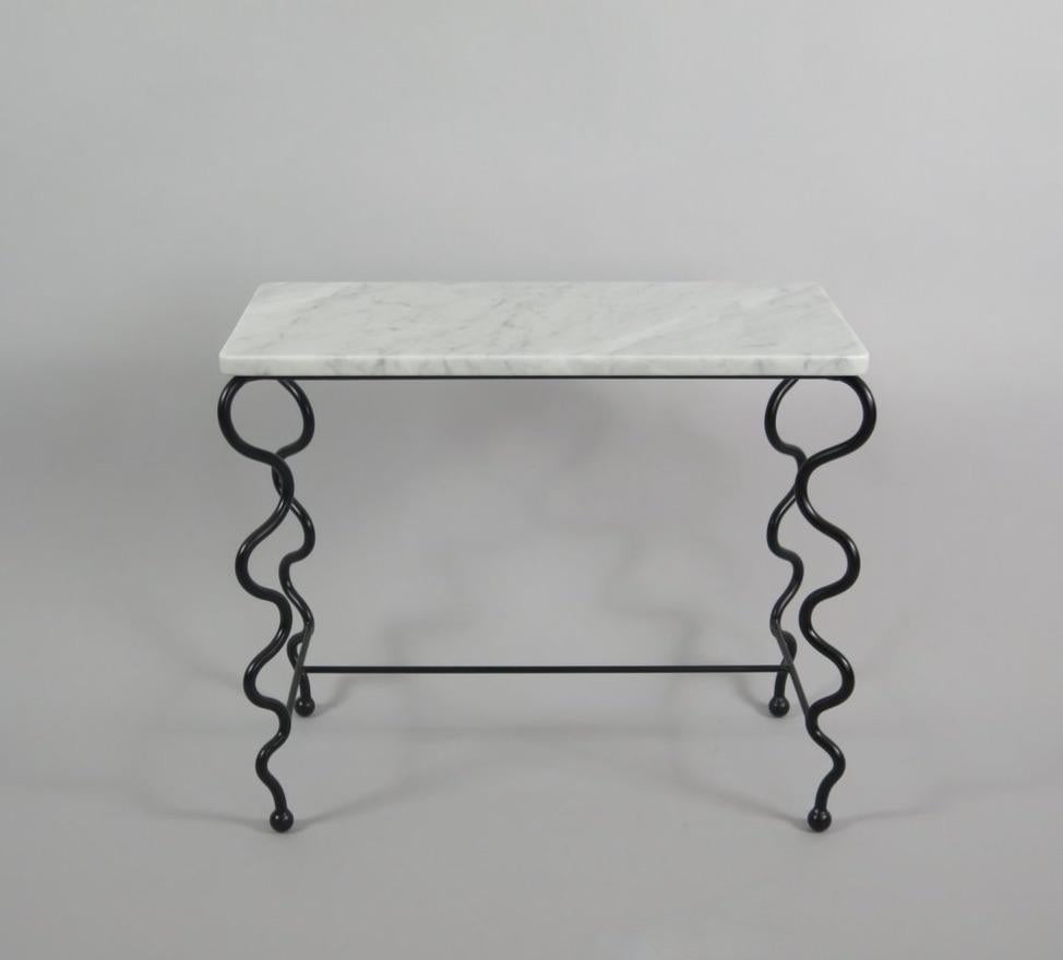 Black wrought iron base with undulating legs and Carrara marble top. Each piece is handmade by our skilled artisans in the United States.

Please inquire for customization requests.
