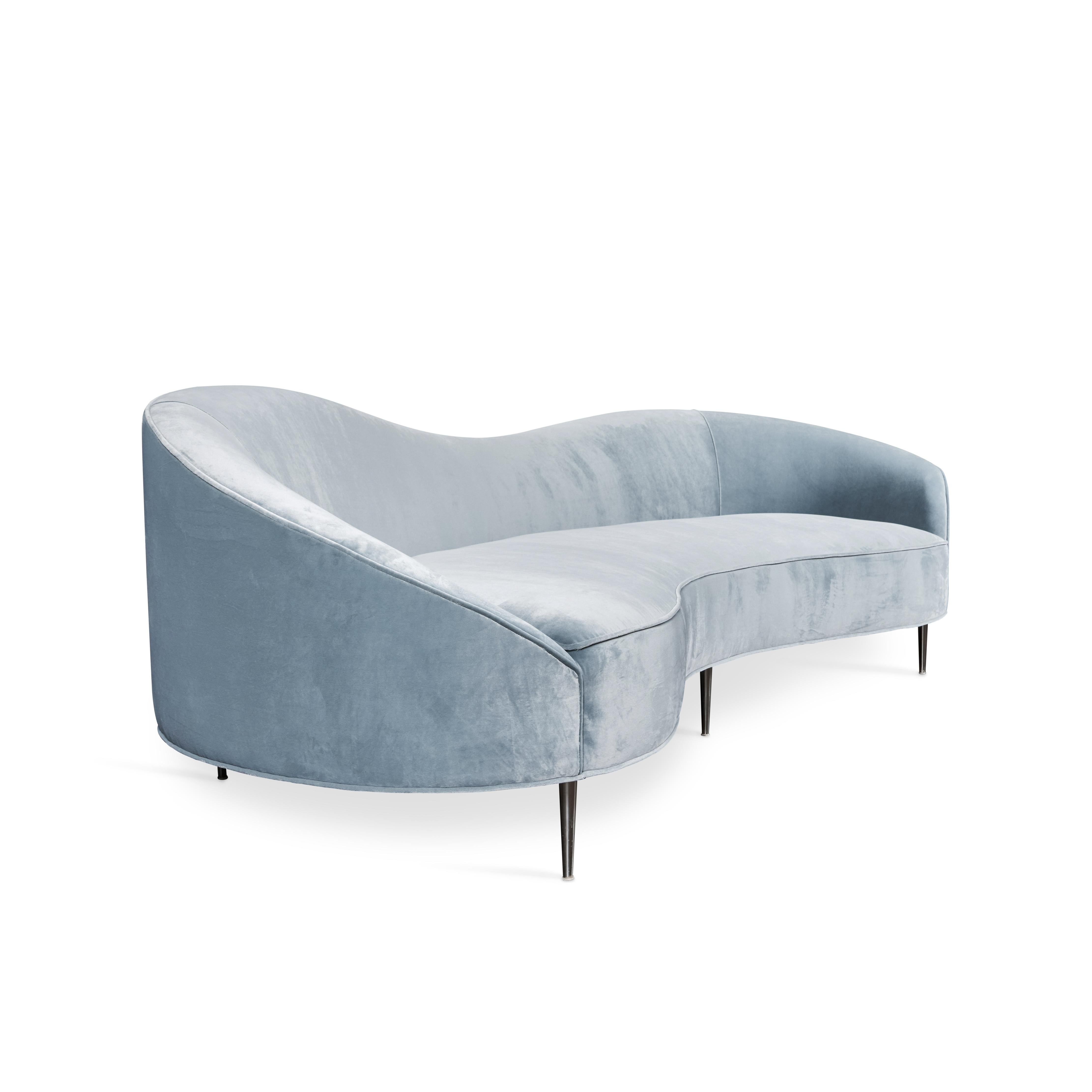 Contemporary sofa in a curved serpentine shape with polished chrome legs.  Sofa has been newly reupholstered in a lush pale aqua Corraggio velvet.