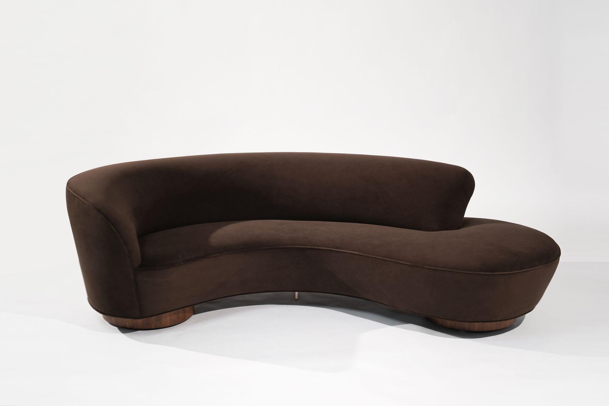 Experience the timeless elegance of the Serpentine Sofa by Vladimir Kagan for Directional, circa 1970s. This iconic piece has been fully restored and reupholstered in luxurious chocolate velvet by Kravet. The sofa features new walnut plinth supports