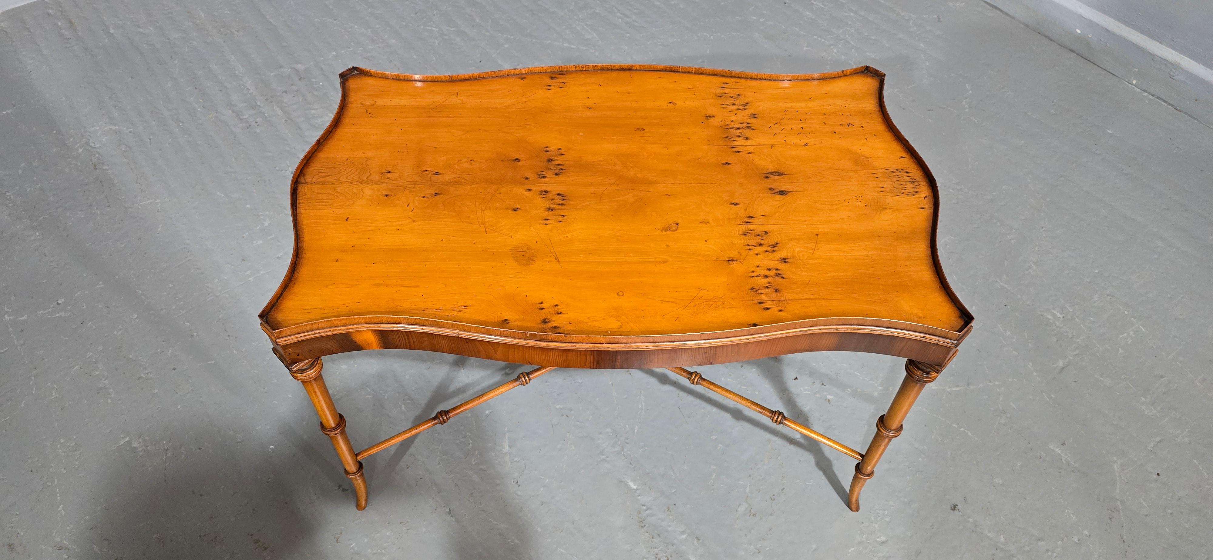 A nice quality deep serpentine coffee table with fine gallery, bamboo style legs and under stretcher, in good overall condition.

18