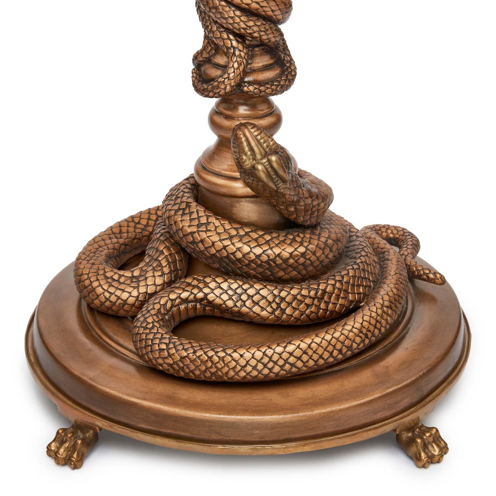 In our House, nobody puts side tables in the corner. Designed to take pride of place in any room, the SERPENTIS is enwrapped with gilded snakes (intricately carved by hand so that each piece is unique) and comes complete with an elegant glass top as