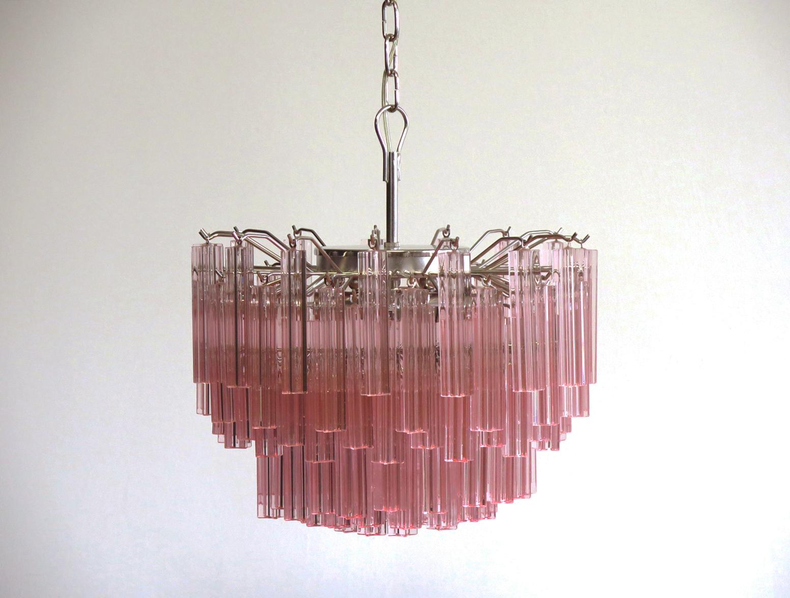 Fantastic vintage Murano chandelier made by 107 Murano crystal prism quadriedri in a nickel metal frame. The glass has a slightly pink color.
Period: 1980s
Dimensions: 45.25 inches height (115 cm) with chain; 15.75 inches height (40 cm) without