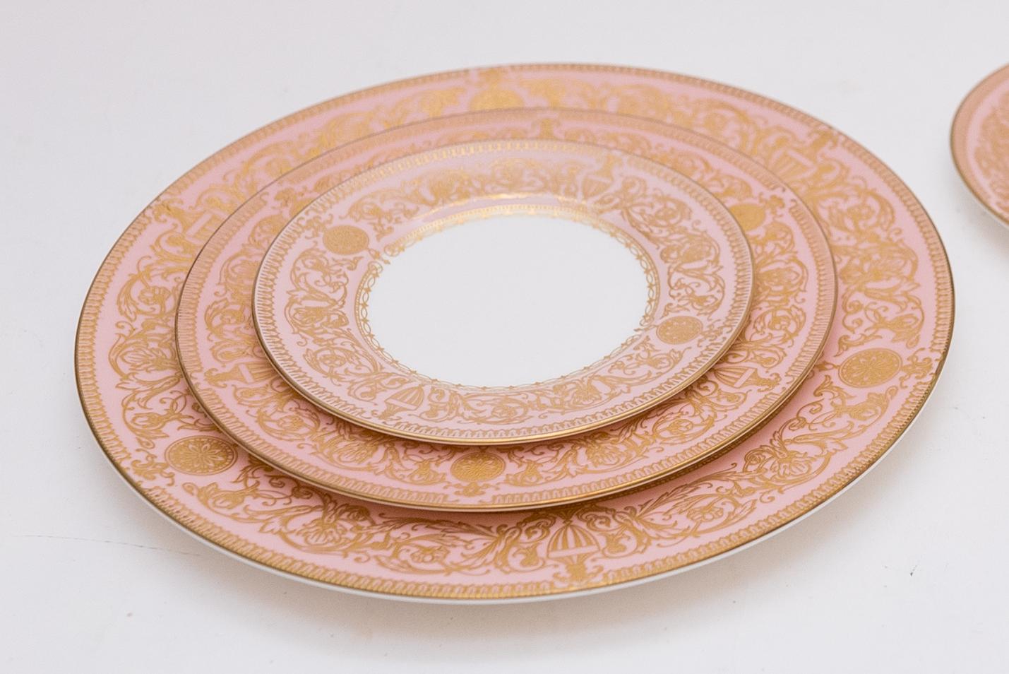 Pretty soft coral pink and embossed gilt dinner service by Royal Worcester. The service is in great condition and features a crisp white porcelain with pink and gold collar decoration. This set includes

12 Dinner Plates Ten and Three Quarter Inch