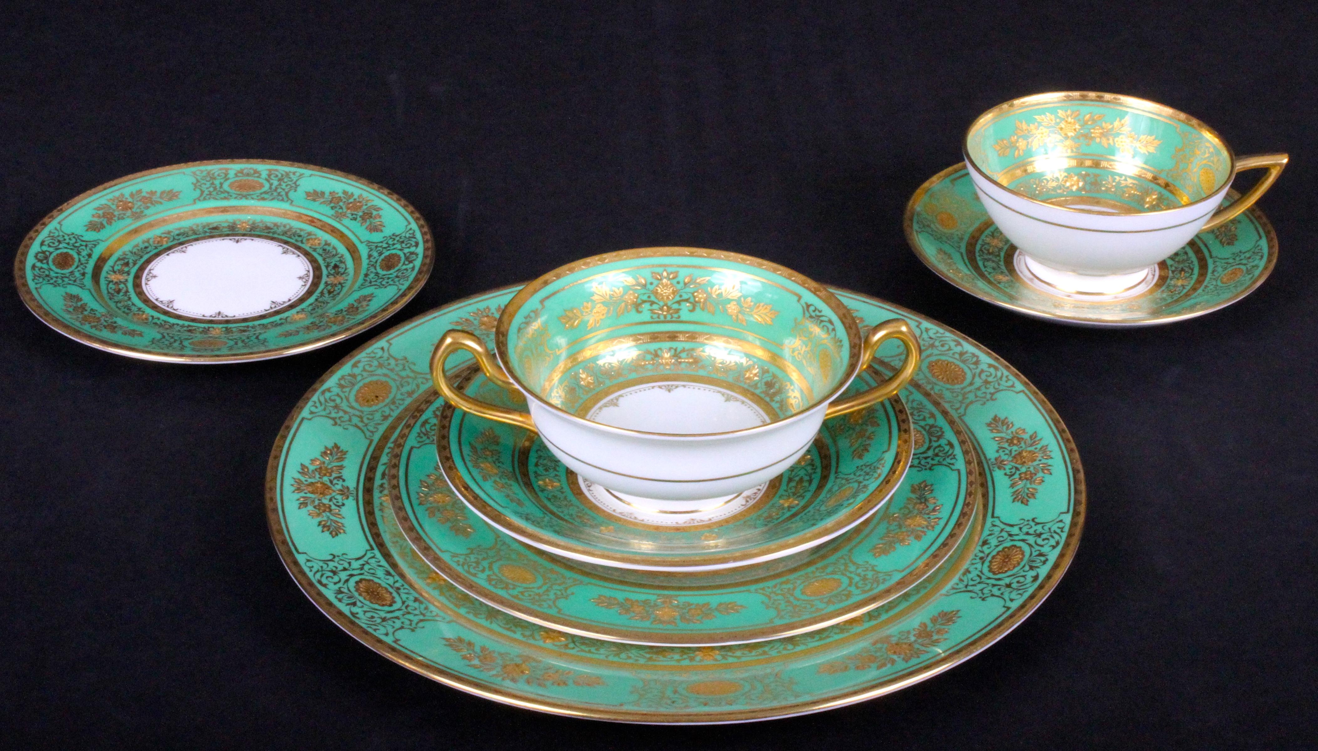 Here is a rarely available large gilded service for 18 in green from Minton, Stoke-on Trent, England. This ornate and beautiful pattern is called Argyle. The set includes dinner, salad or dessert and bread plates, soups bowls, cream soups and