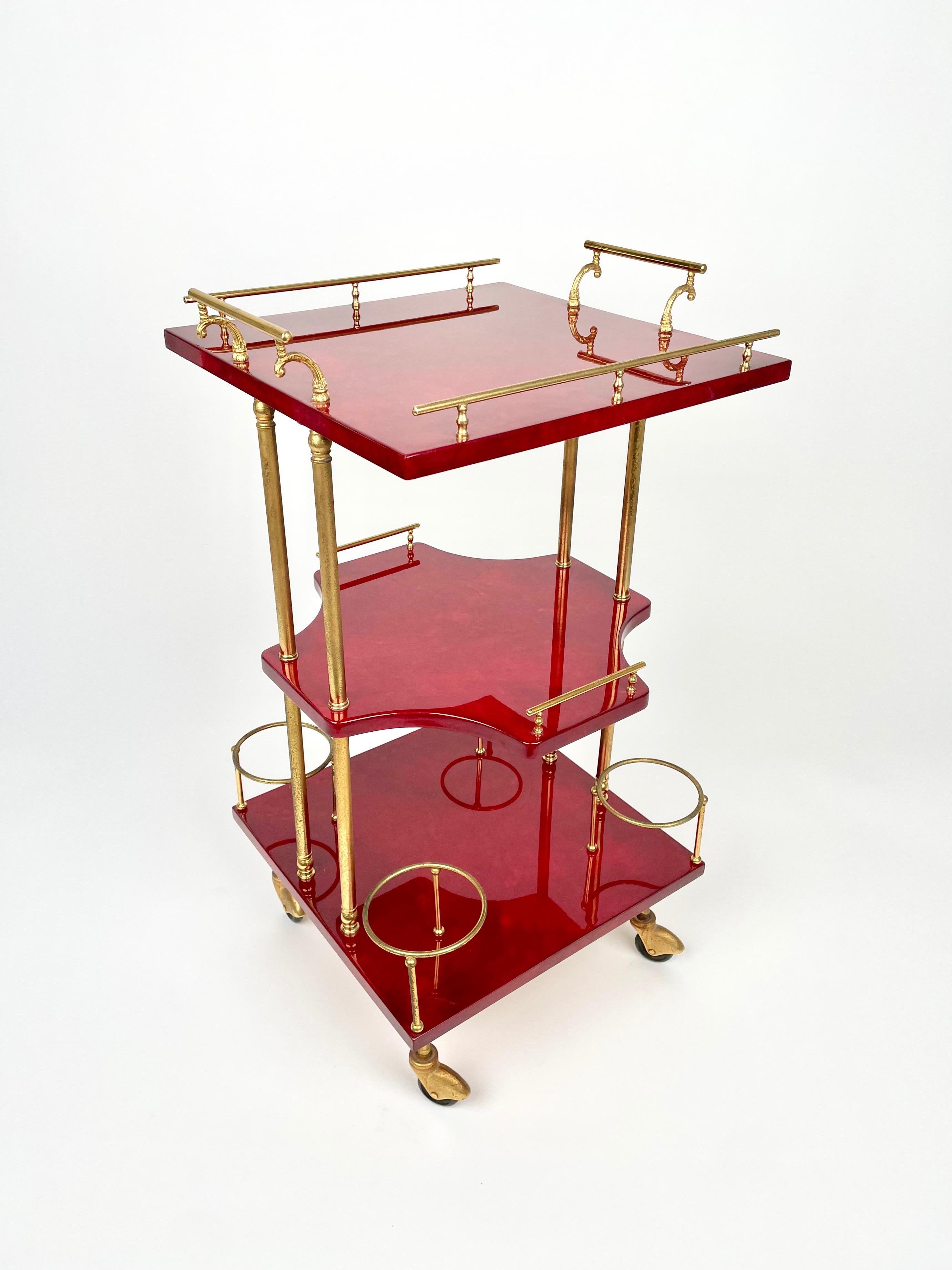 Wonderful bar cart of Aldo Tura in lacquered goatskin and brass.

This serving cart was executed, circa 1960 in a red parchment. 

The original label is still attached on the botton, as shown in the pictures.

Along with artists like Piero