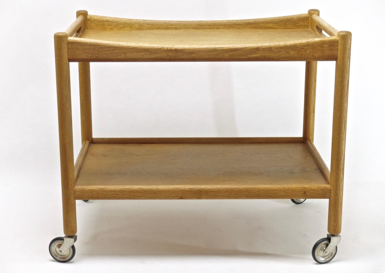 Bar trolley, serving cart by Hans J. Wegner for Andreas Tuck made of solid oak wood profiles with a distinctive wood grain. With original stainless steel wheels and rubber tires.

The original branding is present below.

Dimensions 73 x 48 x H