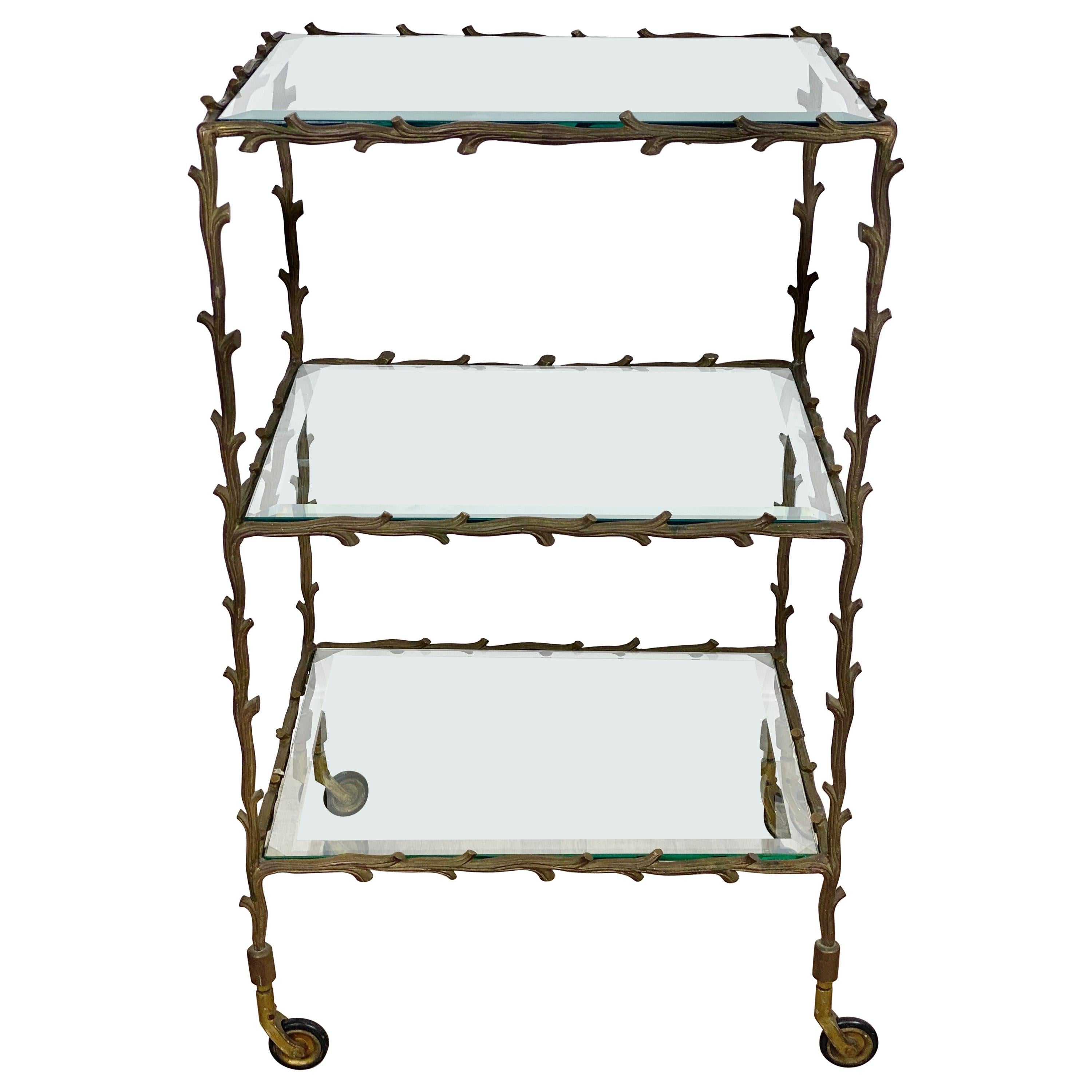 This Maison Baguès serving cart trolley with very animated brass legs of branches (not the typical faux bamboo) which make it more rare. Three glass shelves. Made in France, circa 1950.
The vegetal and wood shaped design ornament is very organic