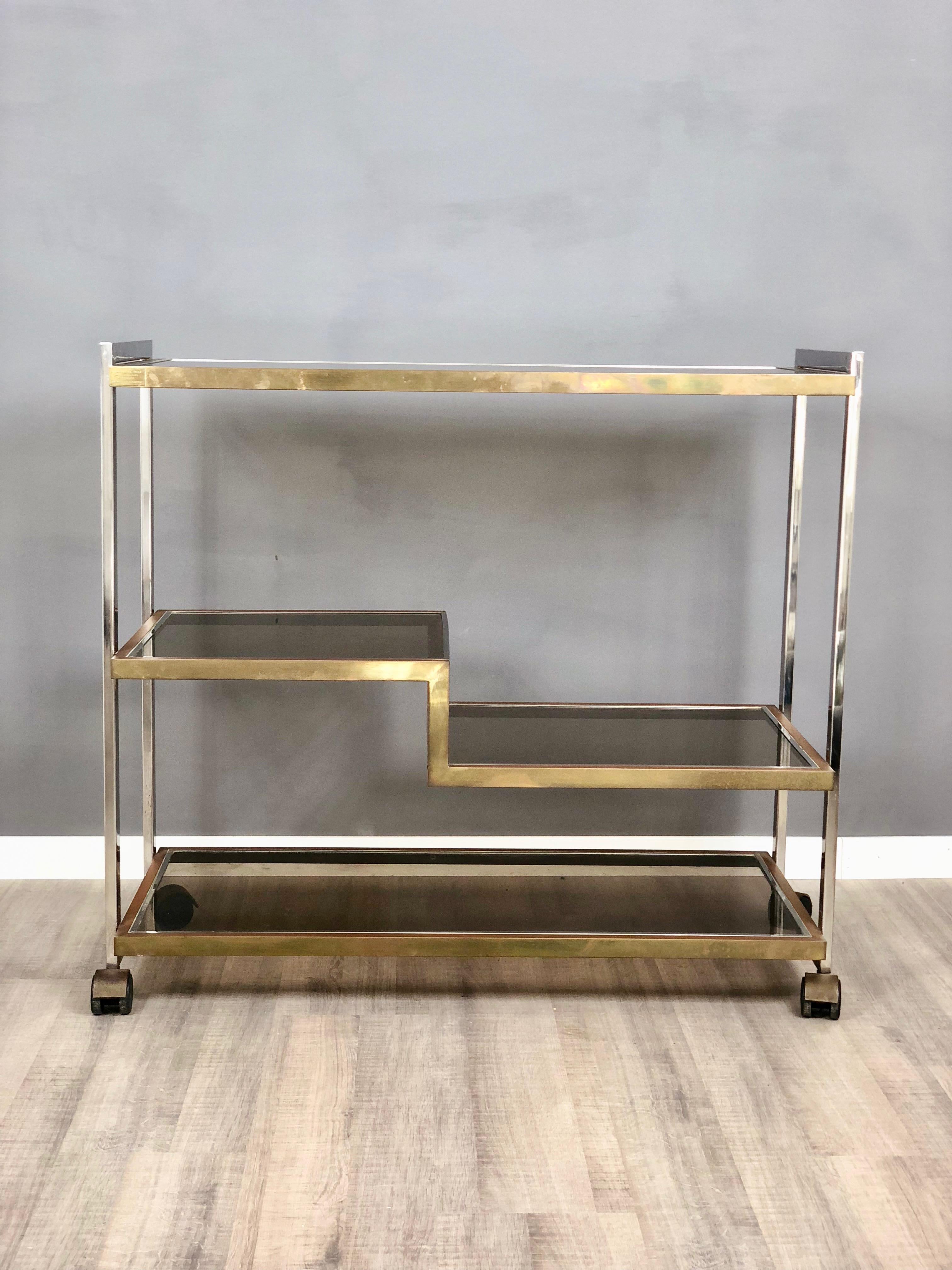 Trolley in brass, chrome and smoked glass. Designed by Serantoni & Arcangeli for New Ideas Inox.
     