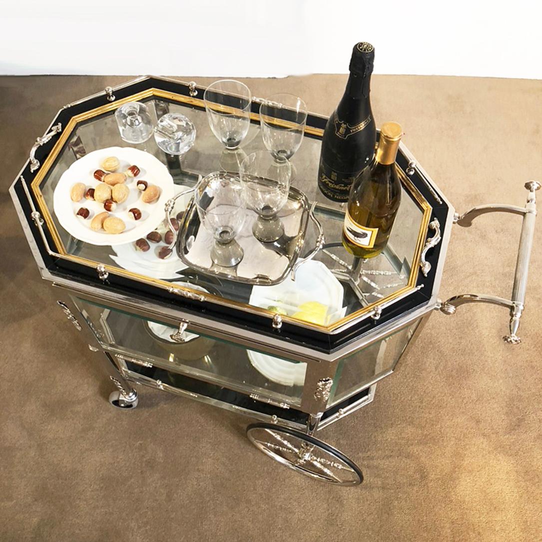 Serving or bar cart. Silver late l and beveled glass. Brass railing around the tray top. Stamped Germany. Side door drops down and the top lifts off as a tray.
Complimentary delivery in the immediate Los Angeles, Beverly Hills area.