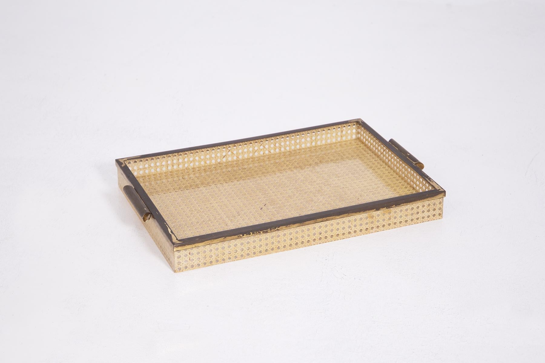 Elegant and well-made table set consisting of a tray, 4 under plates and an ashtray signed by the great Actor Alberto Sordi. Designed in 1970. The set is made of Lucite plastic with a dense rattan latticework inside, almost forming an embroidery.