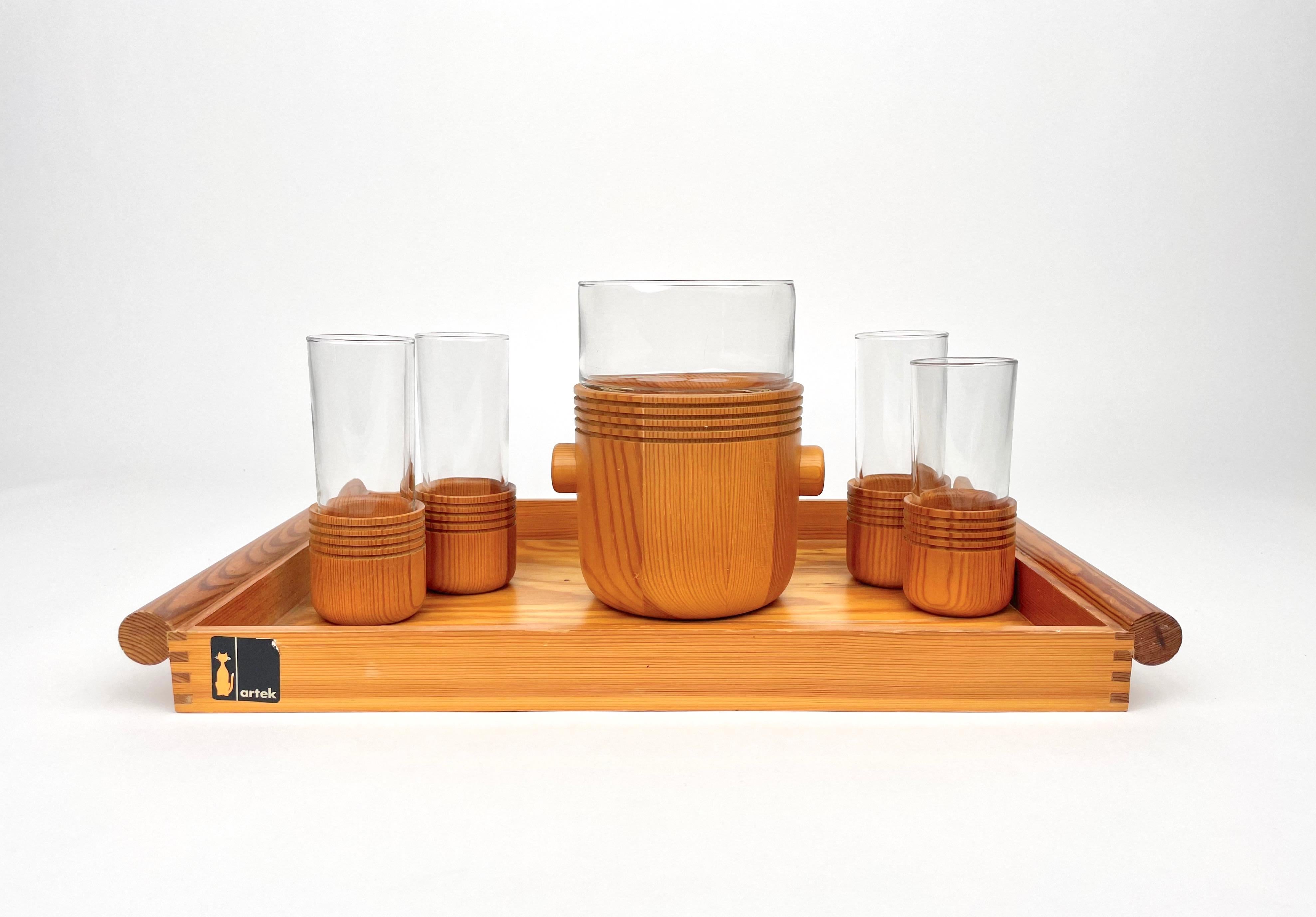 Tray set composed of a tray, four glasses, of which one slightly smaller than the other three, and an ice bucket in wood and glass by Alvar Aalto for Artek. Made in Italy in the 1960s. 

The original labels are still attached on the bottom of the