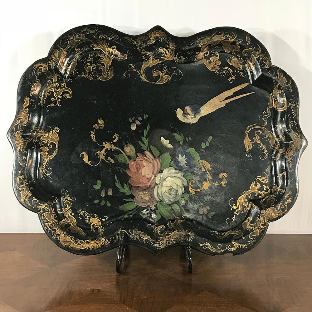 19th century English papier mâché serving tray with an exquisitely hand painted scene of a stylized bird, floral bouquet and rococo bordering with lacquered finish. Perfect for serving in style,
circa mid-1800s
Measures 25 H x 32 W.