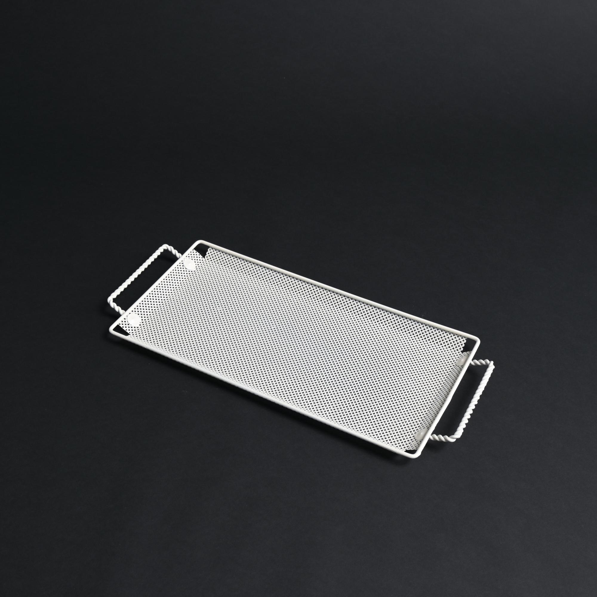 This white metal tray was designed by Mathieu Matégot in the 1950s.

The metalwork displays the hallmarks of Matégot’s style. The metal sheet is accentuated by decorative perforations.

The piece is in good vintage condition.