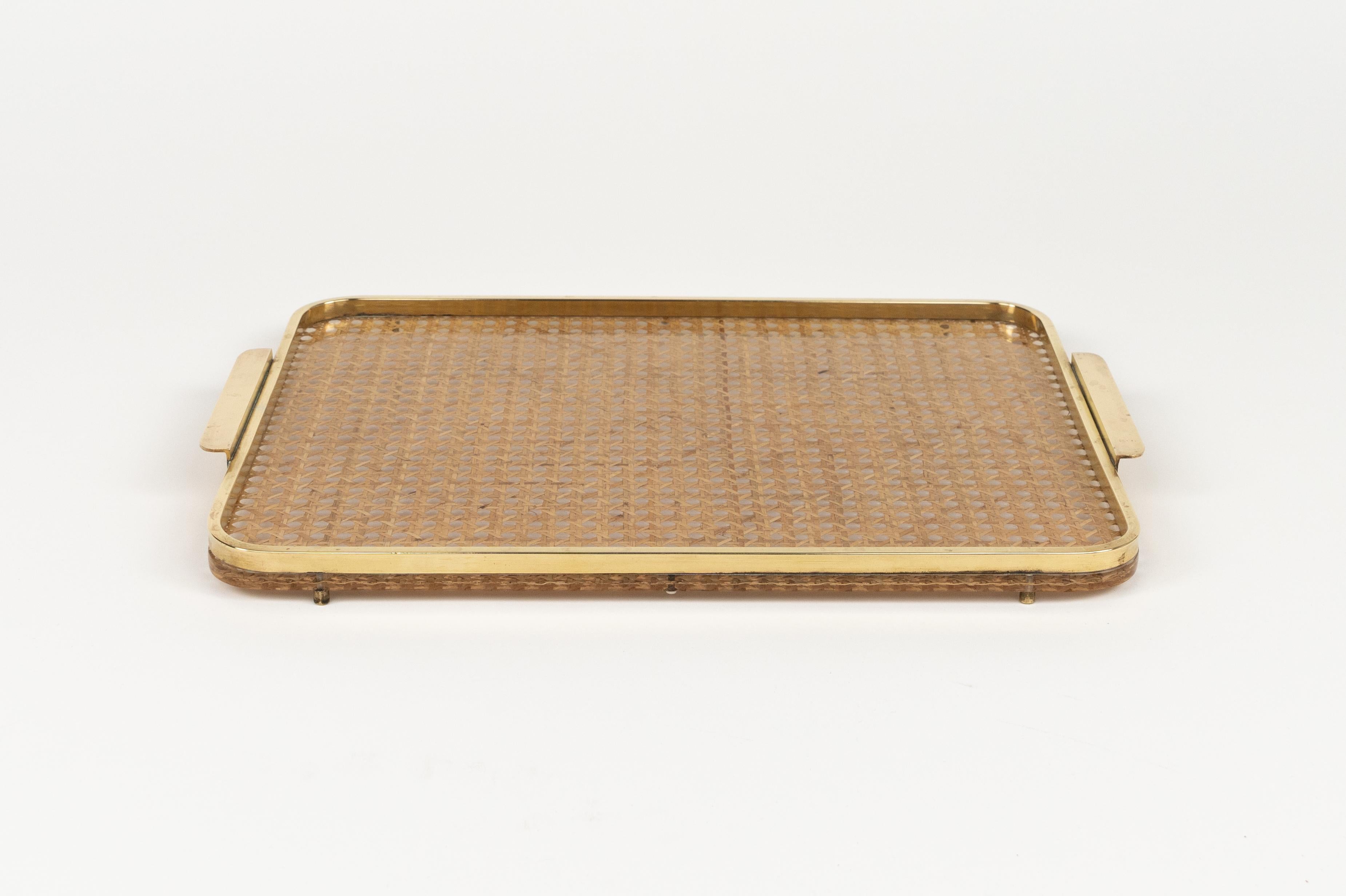 Midcentury beautiful rectangular with handles, serving tray in lucite and rattan with brass border in the style of Christian Dior.

Made in Italy in the 1970s.  

Great accessory for any modern interior.
