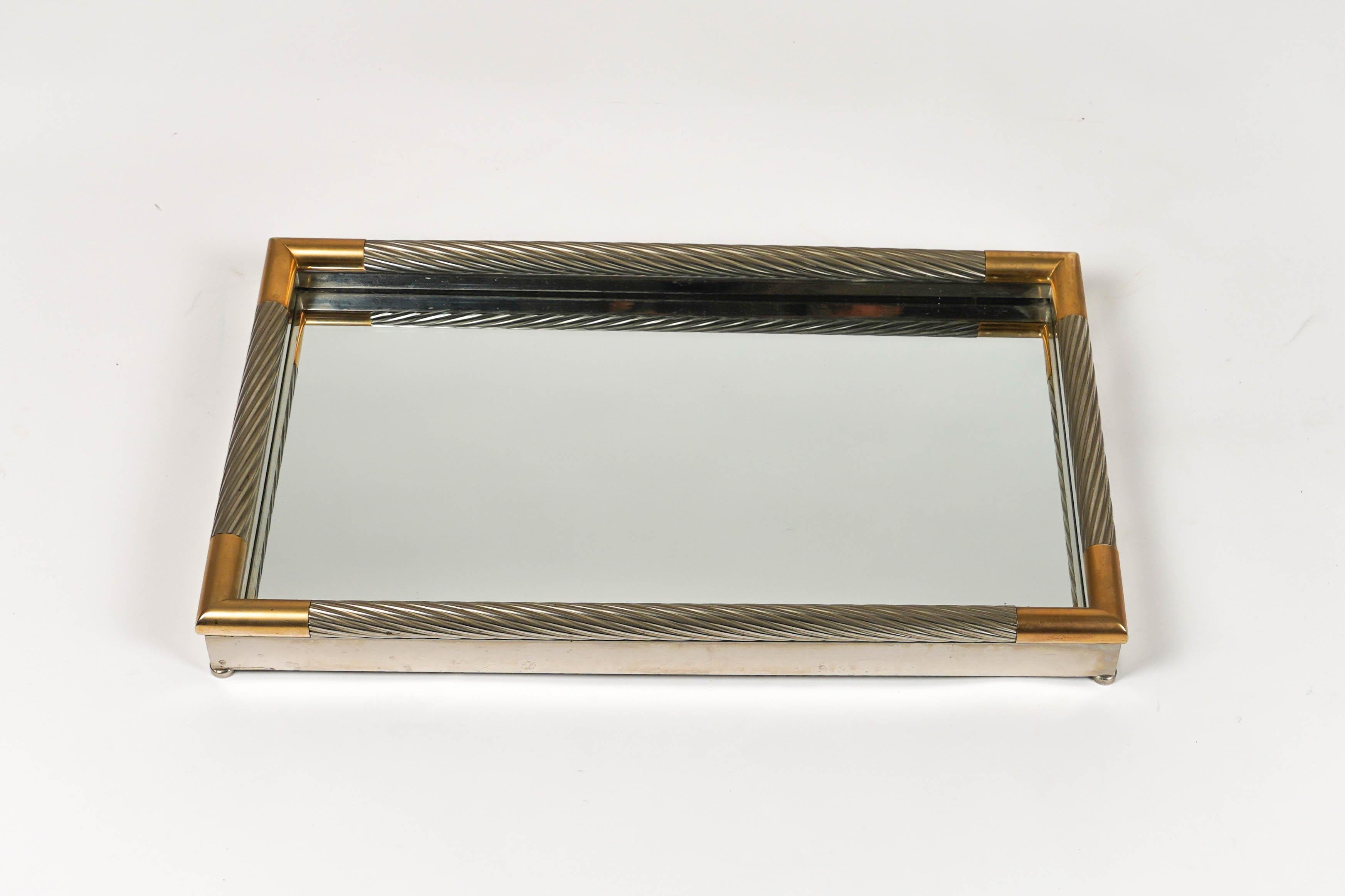 Mid-century  Rectangular vide-poche  or serving tray in silver metal, mirror e corners brass by the Italian designer Tommaso Barbi. 

Made in Italy in the 1970s.

The original label is still attached as shown in the pictures.