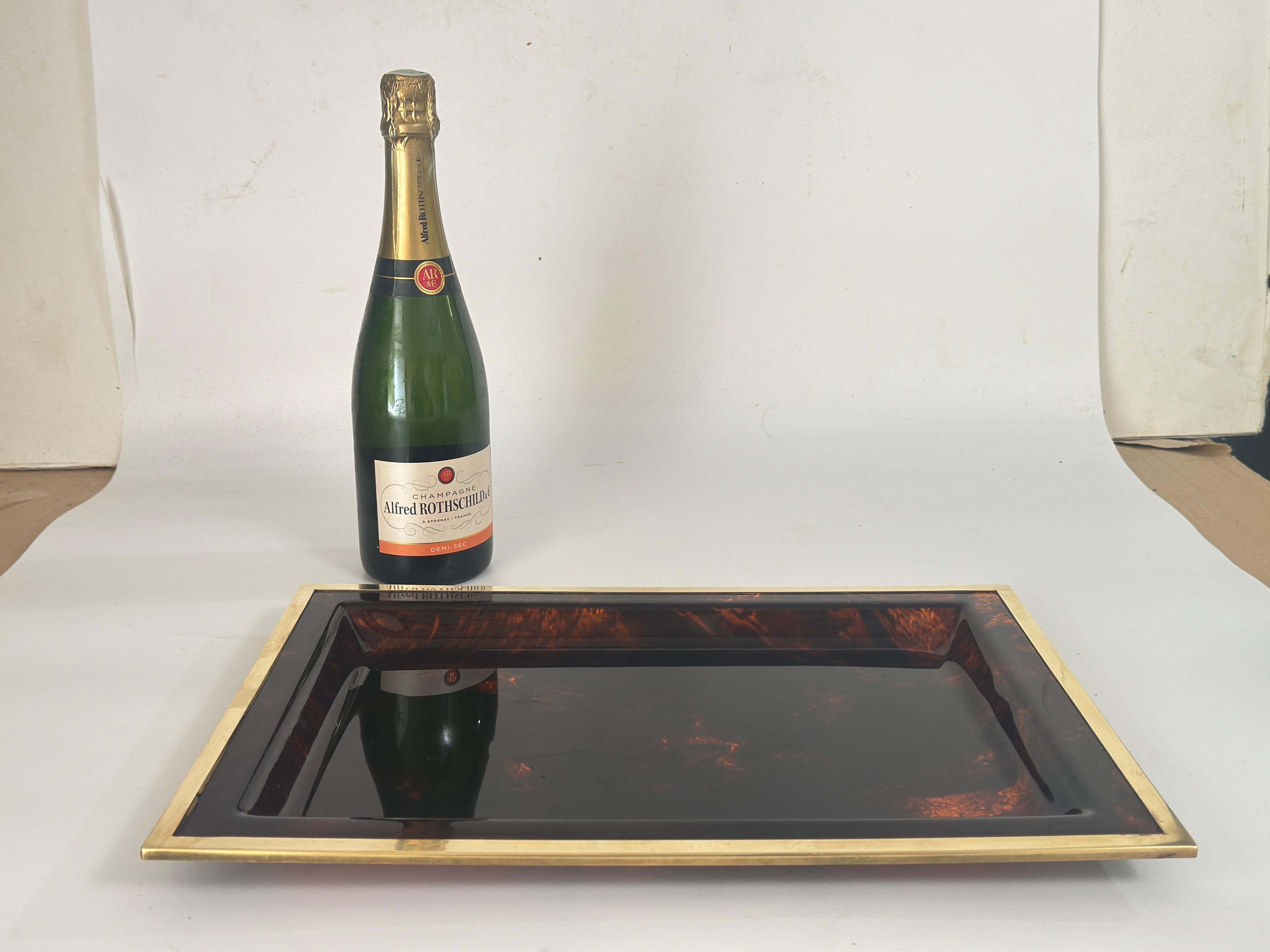 A Mid-Century Modernist serving tray platter attributed to Christian Dior Home Collection, circa 1960s. Large rectangular shape with Lucite in faux tortoise shell pattern and color and brass border.