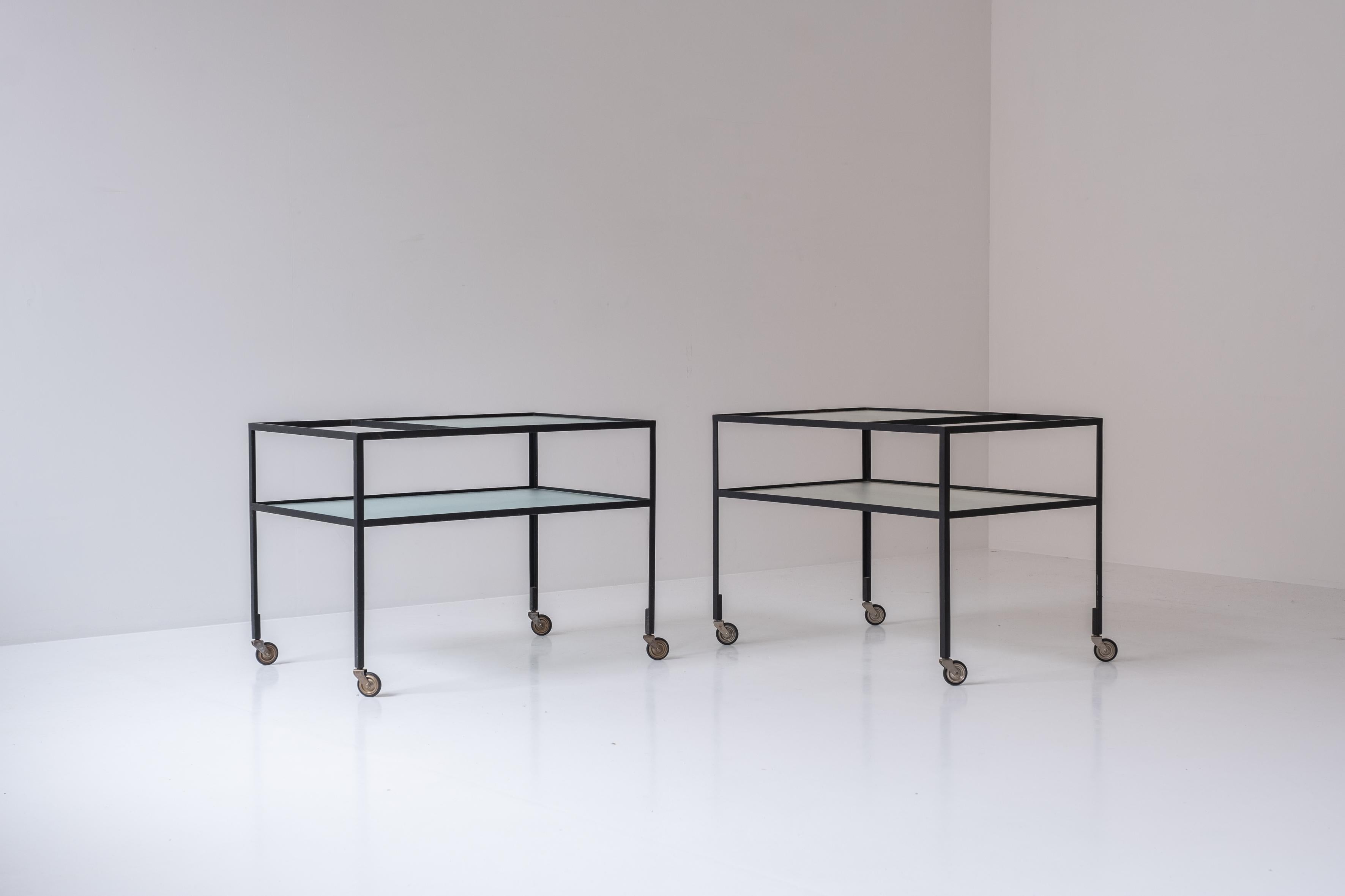 Early edition serving trolley by Herbert Hirche for Christian Holzäpfel KG, Germany 1956. This bar cart features a black lacquered steel frame and holds the original ribbed glass plates. An identical set is available. Priced per piece. Well