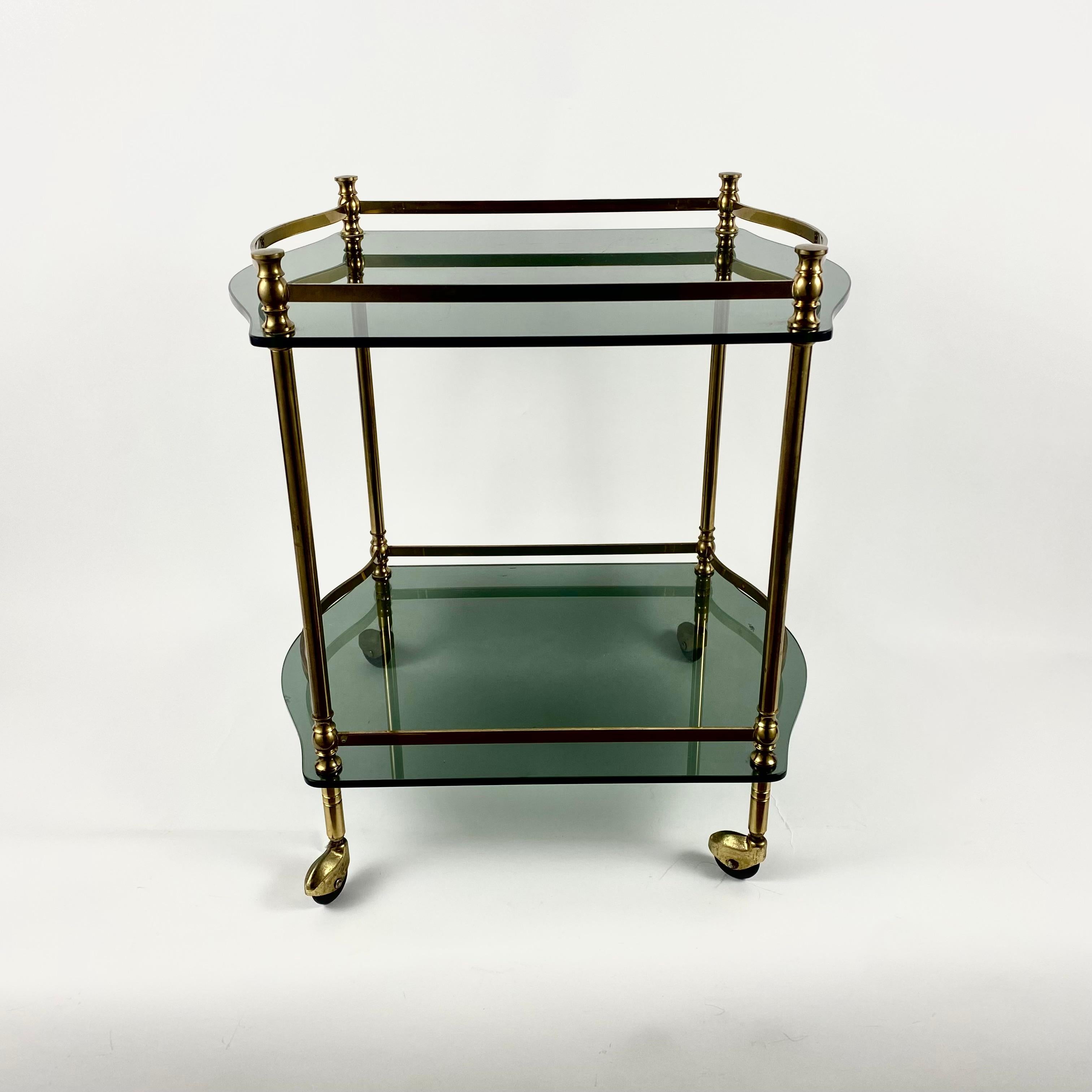 Functional and stylish Serving Trolley with two tinted glass shelves made in Hollywood Regency Style.

Manufactured in France, circa 1950s.

A practical model, indispensable in everyday use, will be useful during meetings of a friendly company.

The
