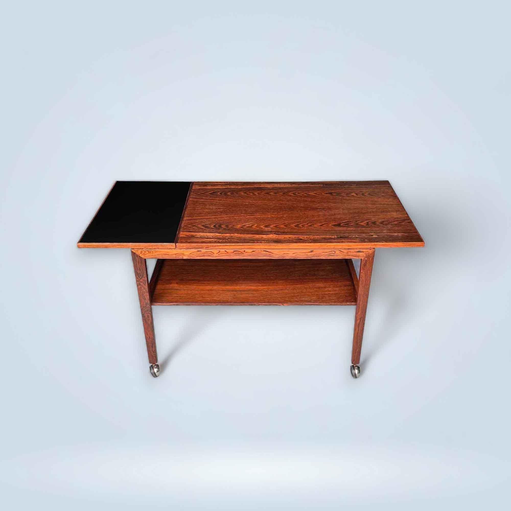 Beautiful Danish trolley designed by Juul Kristensen in the 1960s. The table is made of rosewood, has a black pull-out top, and 4 wheels. With a Danish label at the bottom.

Denmark, 1960s

Designer/Manufacturer: Juul Kristensen

Excellent