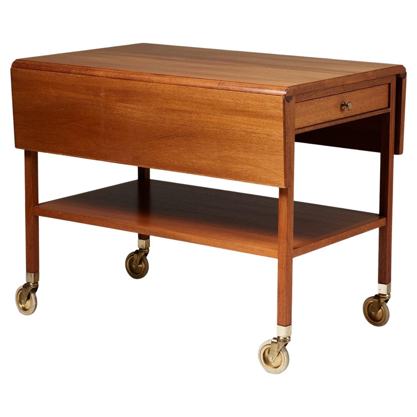 Serving trolley model 756 designed by Josef Frank for Svenskt Tenn, 
Sweden, 1940s.

Veneered walnut and brass.

H: 65 cm
W: 53 cm
Width when fully extended: 89 cm
D: 80 cm

Josef Frank was a true European, he was also a pioneer of what would become