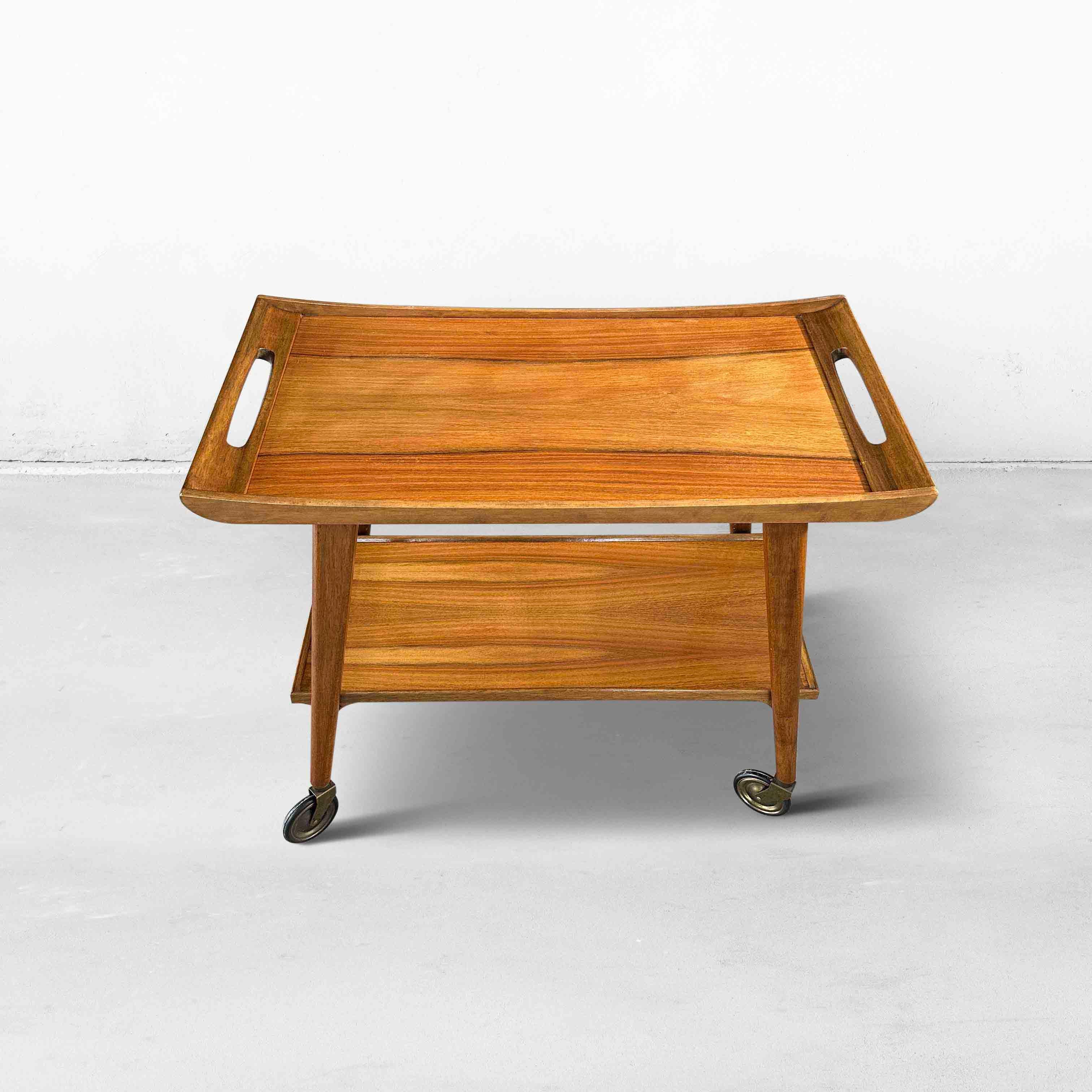 Beautiful serving trolley by Opal Möbel from the 1960s. Made in walnut veneer with solid wooden edges. De original brass wheels still run smoothly. Labels 'Opal Möbel' are present on the bottom.

Germany, 1960s

Designer/Manufacturer: Unknown