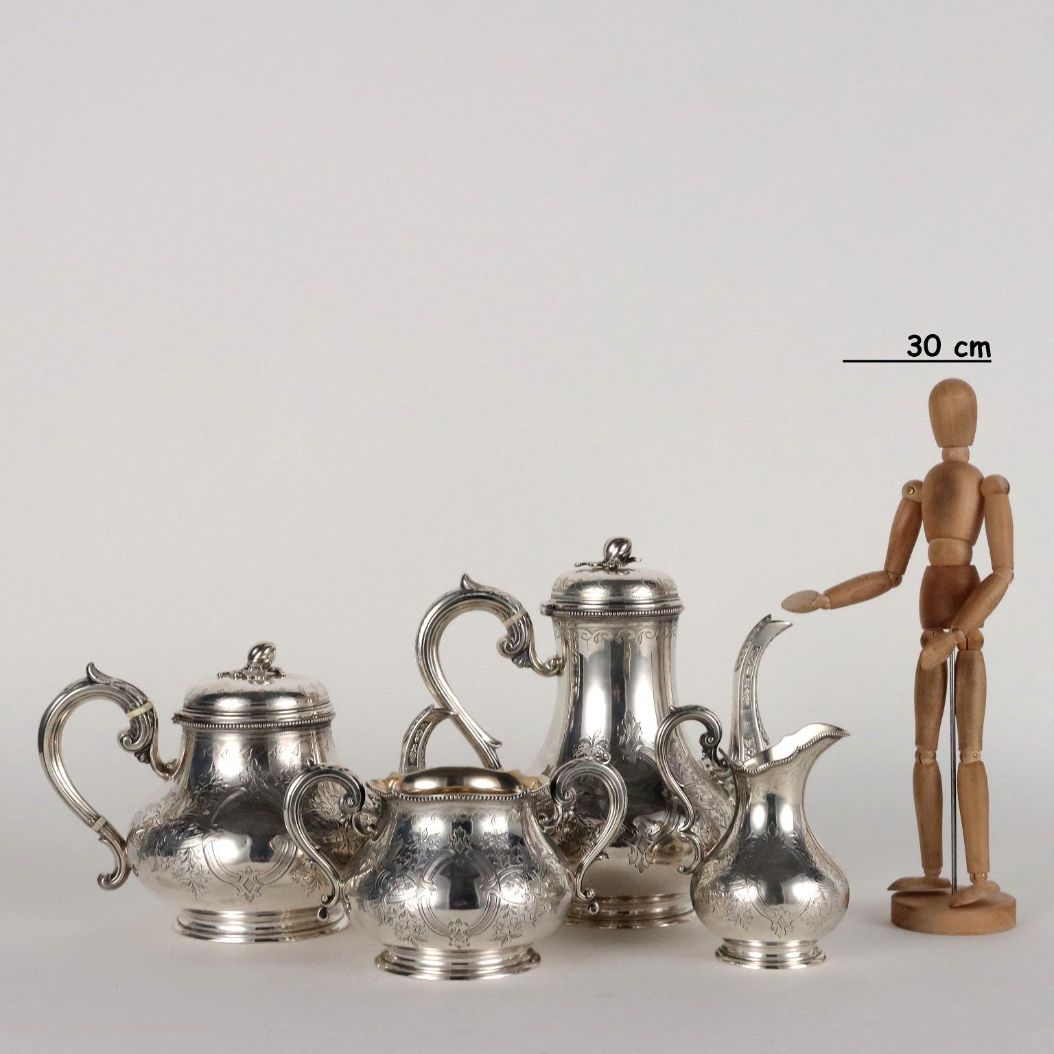 Engraved and chiseled 925 sterling silver tea and coffee set. Fruit and leaf catchers. The service consists of teapot, coffee pot, milk jug and sugar bowl. Silver and silversmith's marks engraved under the bases. 2090 grams.
