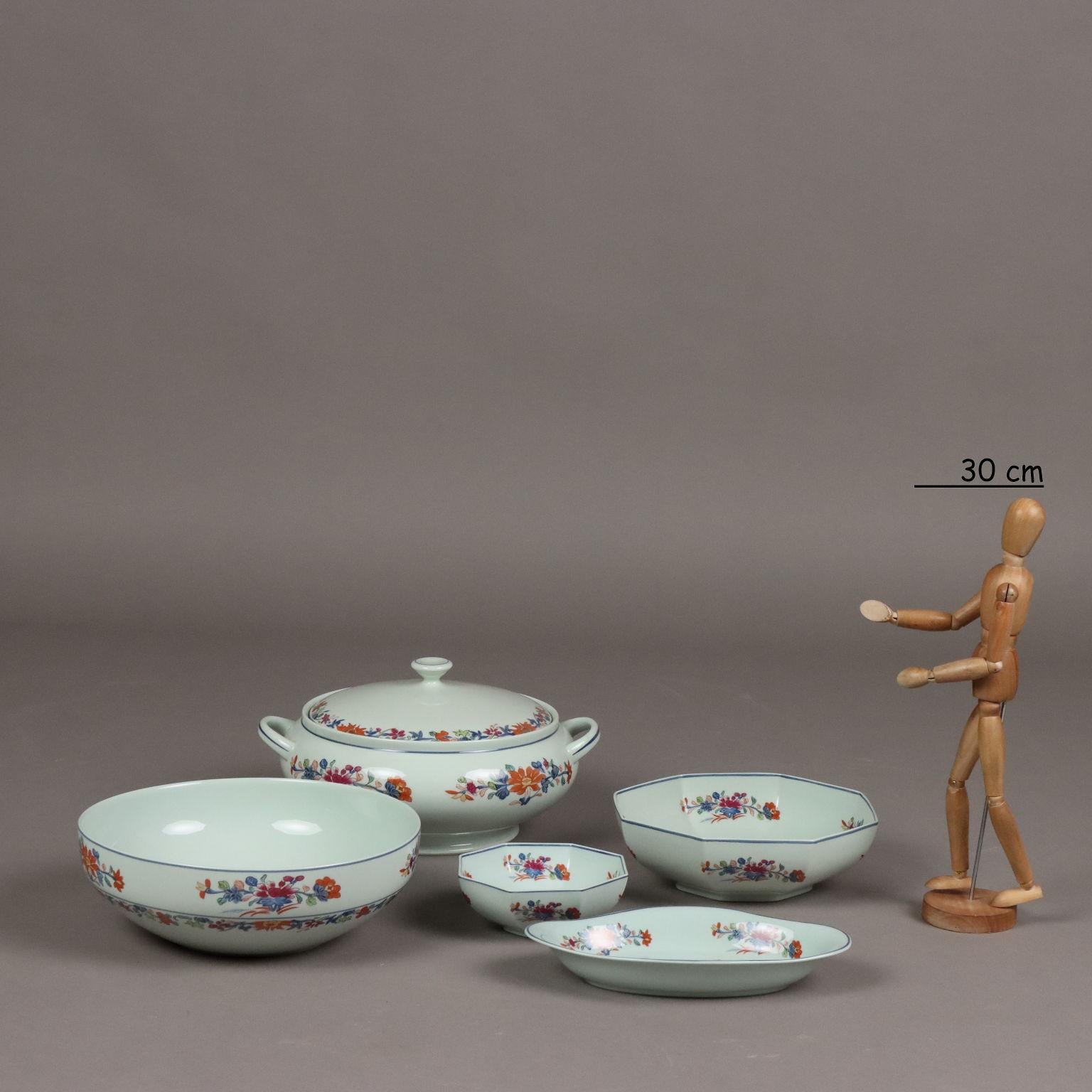 Magnificent celadon-colored porcelain service painted with polychrome decoration depicting Koi carp and Chinese-inspired flowers from the Kiang She period. The service consists of soup tureen, 1 bowl with 11 small bowls, 5 serving plates, 12 bowls,