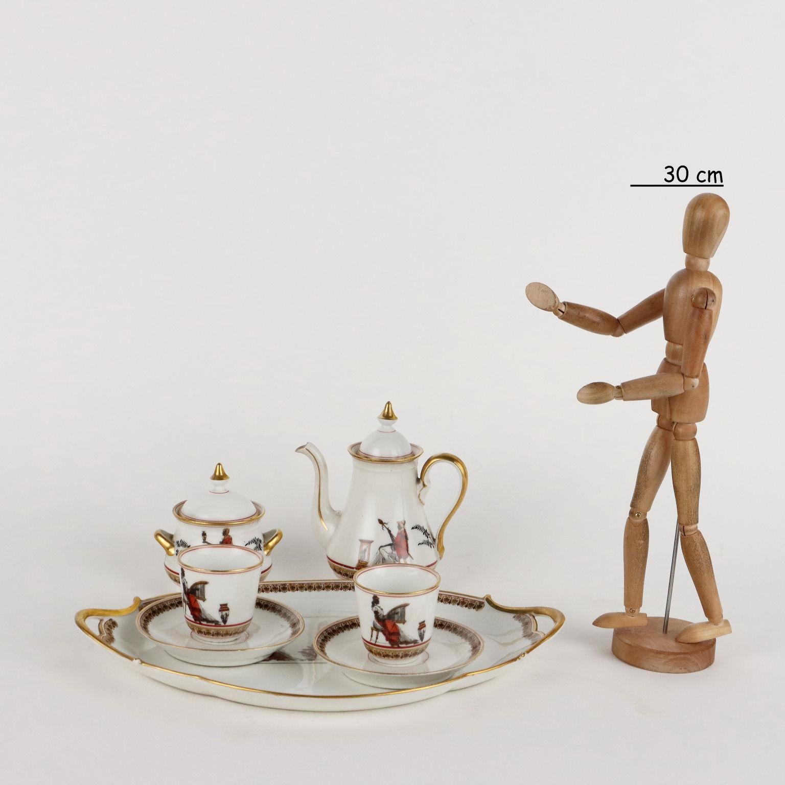 Ginori porcelain tete a tete service with decoration executed by the Richard Ginori manufactory. Decoration with retouché decal with mythological motif. Manufacture mark under the bases. Service consisting of coffee pot, sugar bowl, two cups and